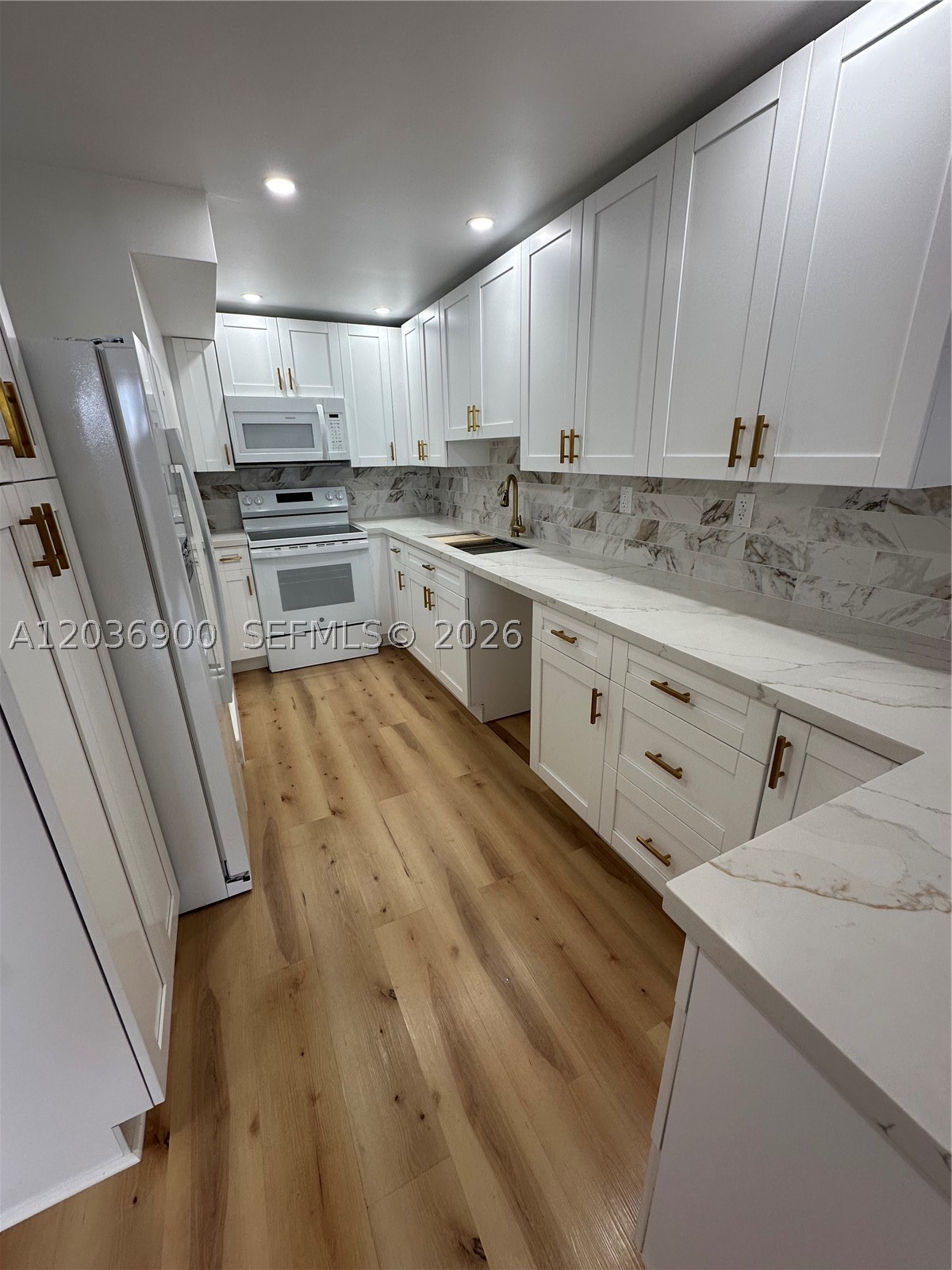 100% REMODELED, Spacious 2-Bedroom, 2-Bathroom at Samari Lake. NEW Vinyl Flooring, NEW high-end Appliances, NEW Kitchen Cabinets, NEW Bathrooms, NEW Impact Windows and Doors. 1st floor with back porch. One assigned parking. Second at a fee.