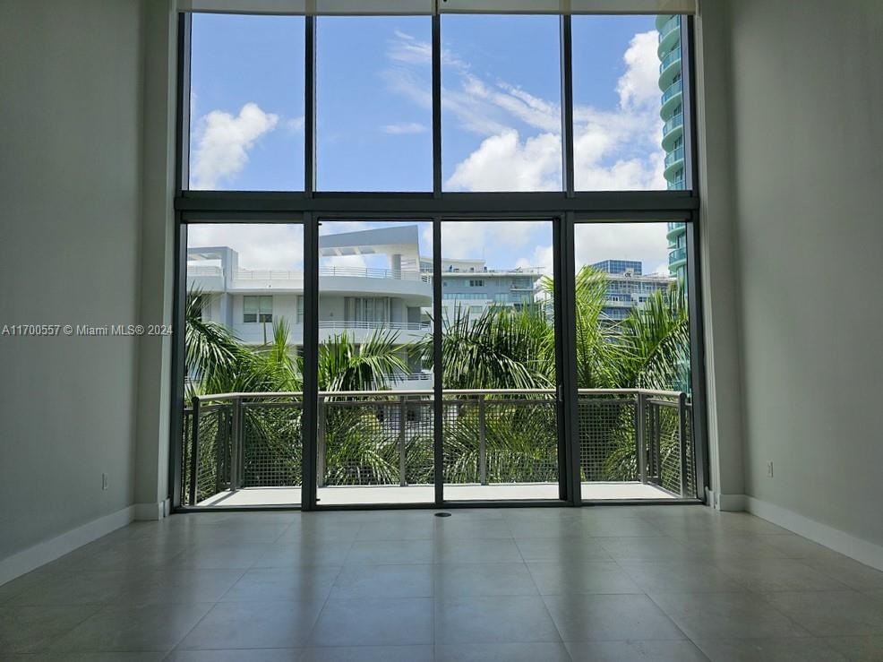 Beautiful one story loft unit in Terra Beachside! This bright, spacious unit offers 20' living room ceilings, with floor to ceiling windows facing Allison Island. Private balcony surrounded by lush palms, with a peek of Indian Creek. Gourmet chef's kitchen with Miele and KitchenAide appliances, Phillipe Starck and Duravit finishes in the bathroom. Conveniently located on Millionaire's Row and just steps from the beach, with local pedestrian access directly across Collins Avenue.  Garage parking space included. Tenant Occupied - 24 hour notice required for showing.