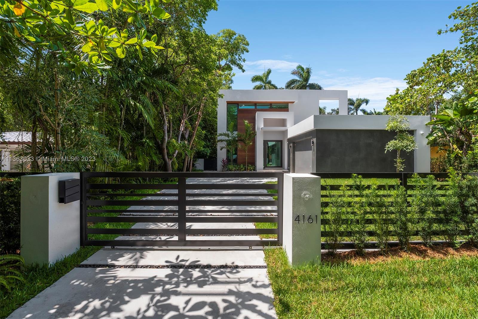 Experience unparalleled tranquility in this 2023 sprawling new estate located in the heart of Coconut Grove. This gated modern retreat is ready for immediate occupancy and boasts exceptional design and state-of-the-art construction, providing a luxurious combination of clean lines. With an open floor plan, the home features large living areas, gourmet kitchen with Quartz countertops, top-of-the-line appl, and glass wine cellar. Enjoy breathtaking views of the resort-style backyard with summer kitchen and pool. Upstairs, the primary suite includes a spa-like bath with floating tub and shower, balcony and boutique-style walk-in closet. Additional features include high ceilings, glass staircase, rare to find 2.5-car garage, and impact windows and doors.