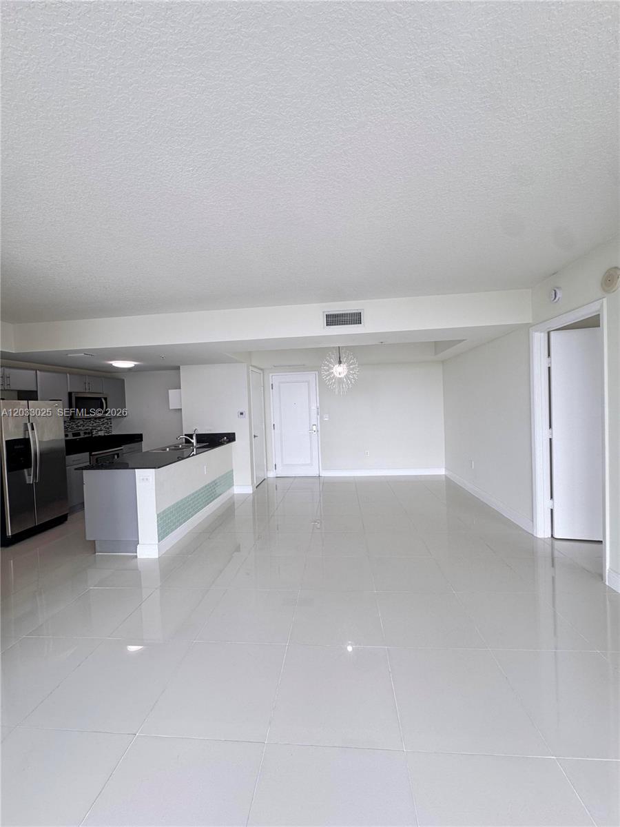 Beautiful 1 bedroom + Den ( Den converted into a Second Bedroom ) 2-bath split floor plan residence, freshly painted and move-in ready. This well-maintained unit offers spacious living areas, abundant natural light, and an ideal layout for privacy and comfort. Includes 1 assigned parking space and 1 private storage unit. Conveniently located near Main Street, the airport, shopping, dining, and major highways, making it perfect for both homeowners and investors.