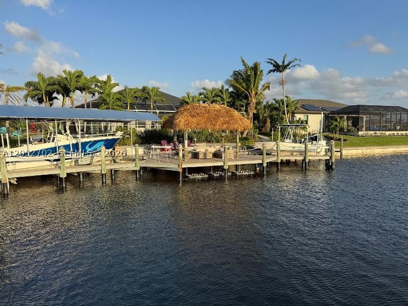 Beautiful house in Cape Coral. Home is a builder lot w/3 lots sorrounded by Tropical palms trees completely upgraded. The house build higher than the properties around it to avoid flooding. Many upgrades include high-end custom wood cabinetry, Huge teardrop Kitchen Island, marble floor throughout, marble walls and Durock to avoid any water damage, power Shades in all windows and doors, Security system with cameras and spotlights, new shingle roof, New PGT polymer impact windows and doors doble glass with Oregon gas, REMOTE CONTROL STORM GUARD SHADES TO PROTECT THE BACK, brand new electrical system , generator wit 500gallon propane tank, Large dock 125 feet include two boat lifts, also come with 2 jet skis lifts,5 under water lights for fish, complete water system, for the entire home. Golf access home that takes you straight out to Matlacha path without the need going trough the miserable mile..