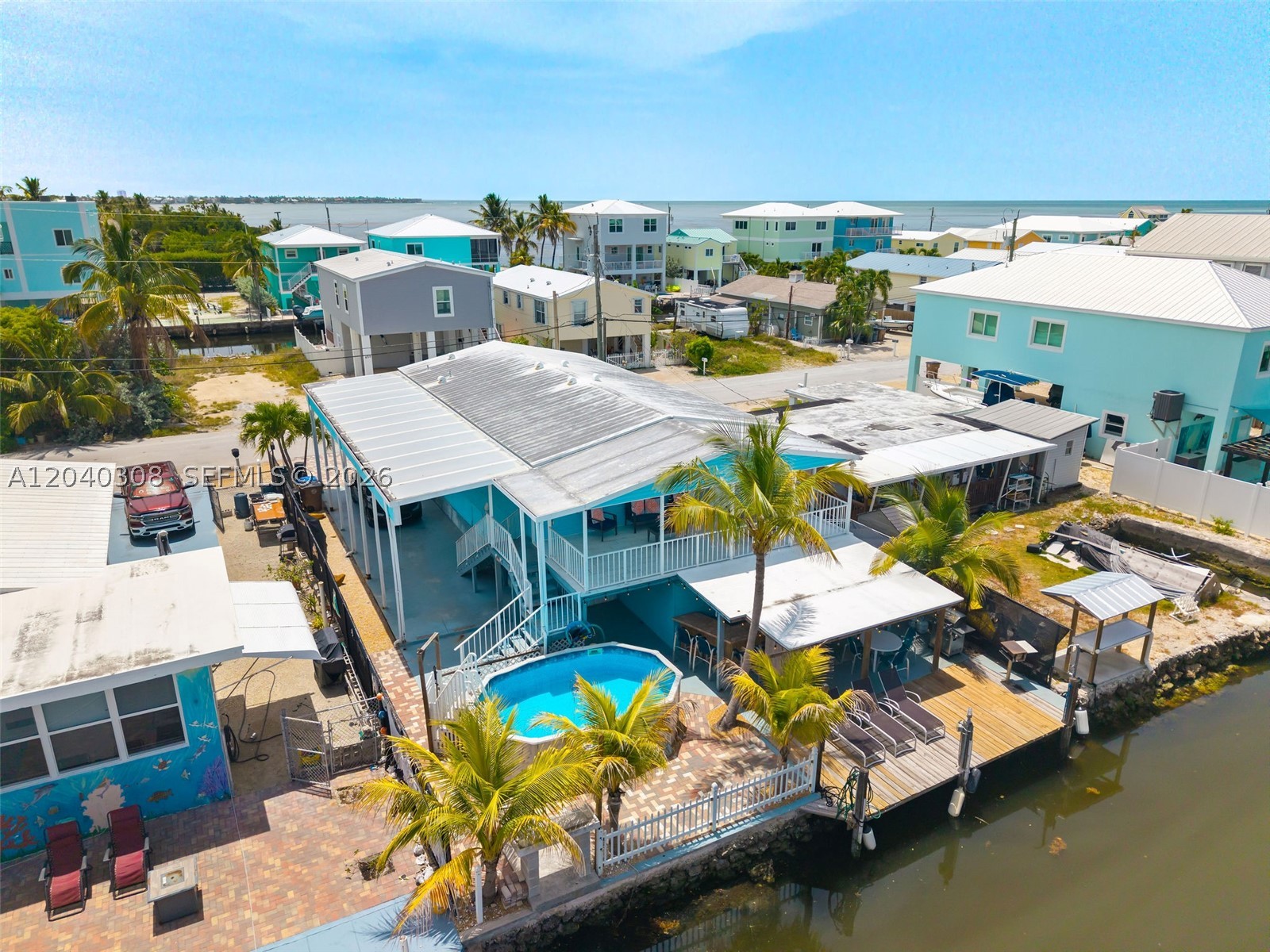Welcome to your slice of paradise in the heart of Marathon! This beautifully updated canal-front retreat offers the ultimate Florida Keys lifestyle with direct boating access, private dockage, and a backyard designed for year-round enjoyment. Whether you’re seeking a full-time residence, vacation getaway, or income-producing investment, this property checks every box.

Inside, you’ll find a bright and inviting open-concept layout featuring updated flooring, a modern kitchen, stylish finishes, spacious bedrooms, and beautifully renovated baths. The coastal-inspired interior is move-in ready and perfectly complements the relaxed waterfront setting.

Step outside to your private tropical oasis complete with a sparkling above-ground pool, expansive entertaining areas, tiki-style bar, paver driveway, and approximately 50 feet of canal frontage. Boaters will appreciate the private dock, seawall, and quick access to open water for world-class fishing, diving, and island hopping.

Additional features include a metal roof, hurricane protection, ample parking, low-maintenance exterior, and exceptional outdoor living spaces designed to embrace the Keys lifestyle.

Ideally located near restaurants, marinas, shopping, beaches, and all that Marathon has to offer, this waterfront gem delivers the perfect blend of comfort, recreation, and island living. Don’t miss this rare opportunity to own a canal-front retreat in one of the Florida Keys’ most desirable boating communities.