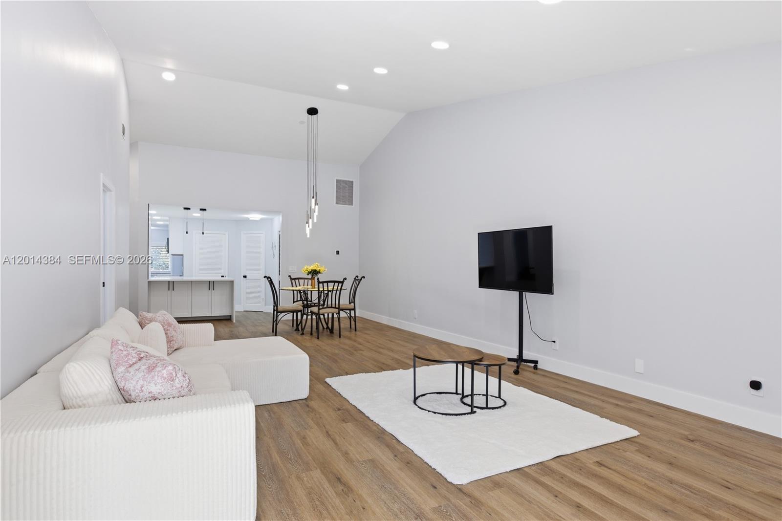 Rarely available, this unit futures open floor plan with impact glass sliding doors leading out to the patio, and also,  vaulted  ceilings. This family-friendly condo/vila offers the perfect blend of convenience and tranquility. Just steps from your front door, you'll find a refreshing pool for leisurely swims. And when you're ready to explore, you are minutes away from major highways, making it easy to commute or shop at nearby stores and restaurants. Plus, with nearby elementary and middle schools, this location is ideal for families. Don't miss this opportunity to live in a quiet, pet-friendly neighborhood!