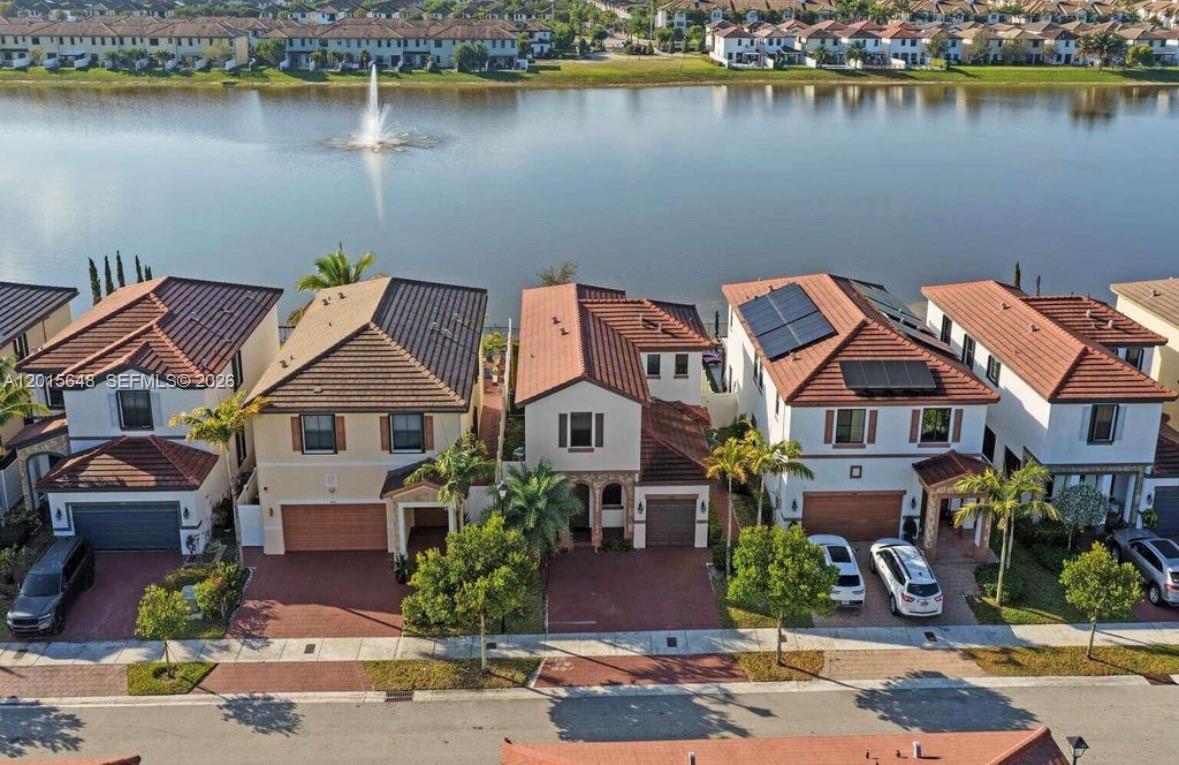 Mediterranean elegance meets resort-style waterfront living in this stunning 4-bedroom, 3.5-bath lakefront home located in the gated community of Aquabella. Built in 2017, this 2,571 sq. ft. residence offers an open-concept layout filled with natural light, soaring ceilings, and seamless living spaces that flow into a modern kitchen, all overlooking serene lake views. The private backyard provides a peaceful setting for relaxing or entertaining by the water. A standout feature is the fully permitted efficiency suite with its own entrance, bedroom, bath, kitchenette, living area, and washer/dryer, ideal for extended family, guests, or additional income. The property also offers a 4-car driveway, 1-car garage, and convenient guest parking nearby. Residents enjoy 24/7 security and resort-style amenities including a clubhouse, gym, playgrounds, and walking paths, all with easy access to major highways, shopping, dining, and schools.