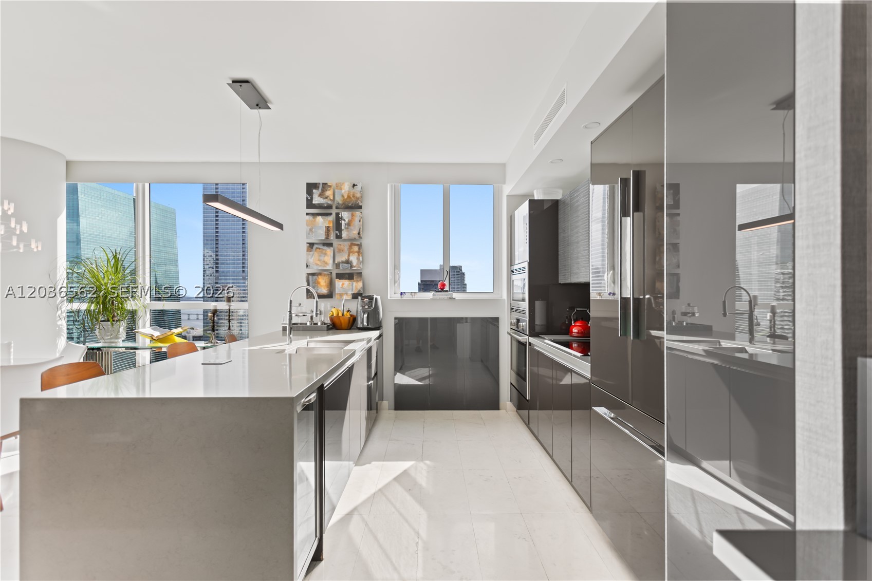 Experience luxury living in this corner 3BR/3BA residence at The Bond on Brickell with stunning ocean and skyline views. Floor-to-ceiling windows fill the unit with natural light, while the oversized balcony is accessible from multiple rooms, creating seamless indoor-outdoor living.

Thoughtfully upgraded throughout, the residence features Italian marble flooring, designer wallpaper, electric blackout blinds, custom-built closets, a custom TV feature wall, and additional pantry storage. The spacious primary suite includes a large walk-in closet and a spa-like bathroom with dual sinks, a soaking tub, and a glass-enclosed shower.

The open kitchen is equipped with Bosch stainless steel appliances, sleek cabinetry, ample counter space, and a built-in wine cooler. Impeccably maintained and never rented, this residence also includes an in-unit washer and dryer and one assigned parking space.

Resort-style amenities include a pool with cabanas, grills, hot tub, steam room, sauna, fitness center, business lounge, valet, 24/7 security, pet walking area, and pet wash station.

The Bond offers strong rental demand, making this residence ideal for both investors and end-users. Prime Brickell location just steps from Brickell City Centre, top dining, shopping, and nightlife.