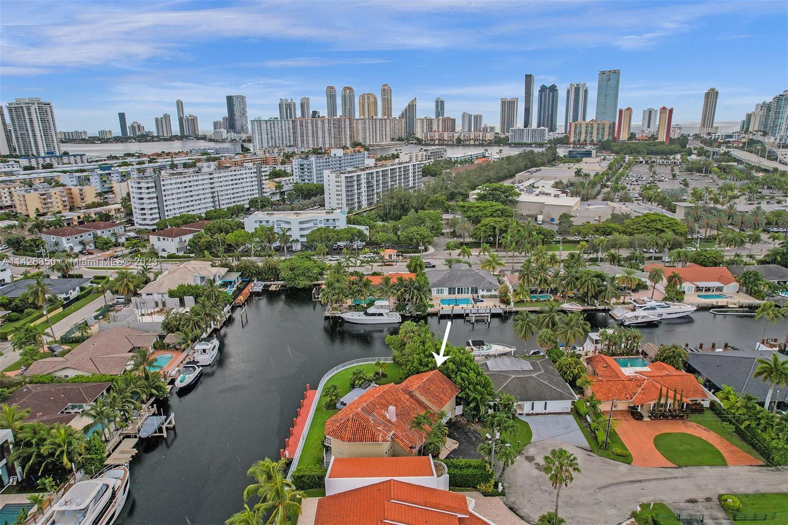 This incredible home is on private cul-de-sac street in a gated community on the water in desirable Eastern Shores. The home is completely renovated & furnished with Marble & wood floors throughout. Master level is in between the first & second story in it's own private wing with balcony overlooking pool, spa & the intercoastal. All bedrooms have own private bathroom with wraparound balcony. Huge kitchen with breakfast counter, stainless steel appliances, wine cooler & gas stove. Backyard is great for outdoor entertainment with heated pool, spa and plenty of room for outdoor activities, including a 65 foot boat dock that can dock a large boat or yacht. The sea wall is 180 feet long all around. NO HOA & just few minutes to beach & Oleta State Park. Short term rentals allowed 3 times yearly