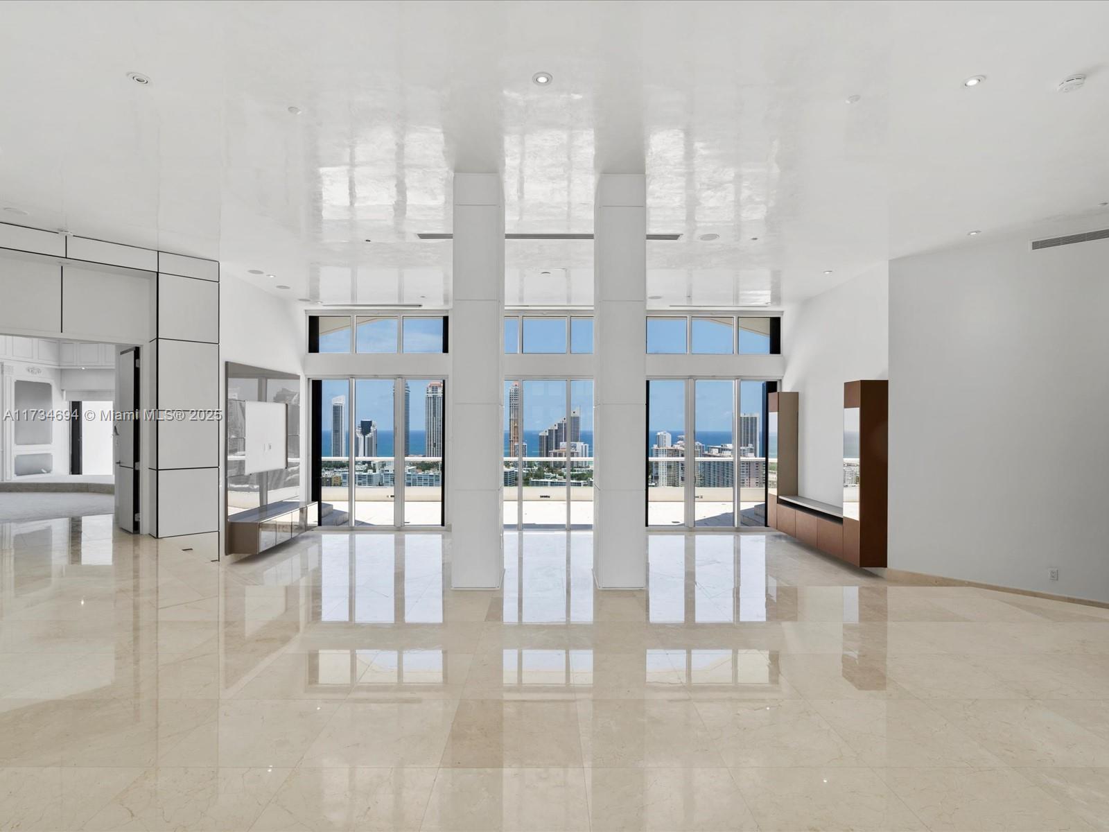 Step into a world of rarefied luxury with this prestigious duplex penthouse at Residence du Cap on the coveted Williams Island. Set on a private island surrounded by serene waters and lush landscapes, this architectural gem spans 9,100 sq.ft. of refined interiors and 3,183 sq.ft. of breathtaking terraces. With 6 lavish bedrooms, 8.5 spa-inspired bathrooms, a private library, den, and staff quarters, every detail exudes sophistication. The grand great room features soaring 14-foot ceilings, while the chef’s kitchen rivals the finest culinary spaces. The master suite boasts dual baths, an indoor-outdoor shower, and expansive walk-ins. Private elevators, including a striking glass hydraulic lift, lead to a rooftop oasis with a pool and spa. Furnished images are renderings. Call today!