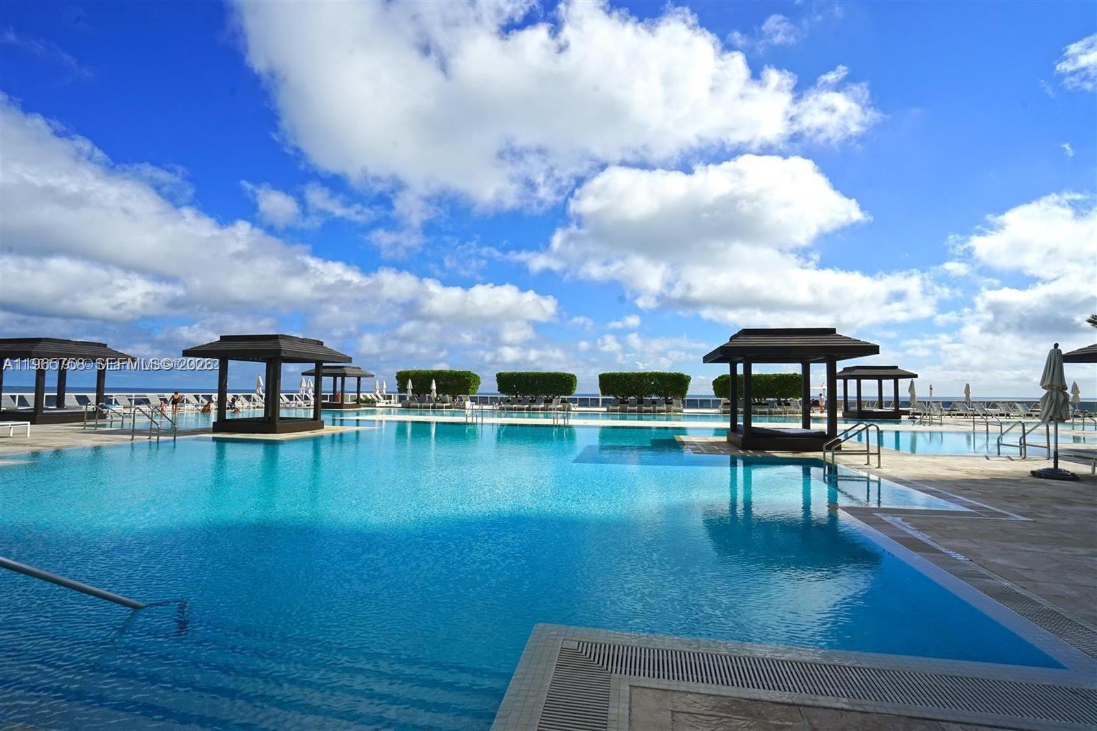 THIS BEACH CLUB OCEANFRONT RESIDENCE IS TRULY A HOME YOU CAN ENJOY!  SPACIOUS IS AN UNDERSTATEMENT This 1 Bedroom, w Den and Full Bathroom has Floor To Ceiling Sliding Glass Doors in the Bedroom and Living Room Letting in Plenty of Natural Light. You will  Feel Pampered as you Treat Yourself to a Soothing Soak in the Jetted Spa Tub- Shower Combination.  Relax and be Swayed in Your Hammock On The Balcony As The Most Awesome Sunset Unfolds Before You! - There's Always Something To See!  The Condo has A Washer/Dryer, Storage and Under Building Assigned Parking.   IF THIS ALL WASN'T ENOUGH ENJOY THE PRIVATE BEACH ACCESS, 5 Heated Pools, Fitness Centers, Sauna , Cold Plunge Pool and So Much More!  Schedule A Massage and other Services at the Private Residents Only Spa....It's All Here!  The Location Without Saying Is The Best ~ Close To Everything and Between Fort Lauderdale and Miami.