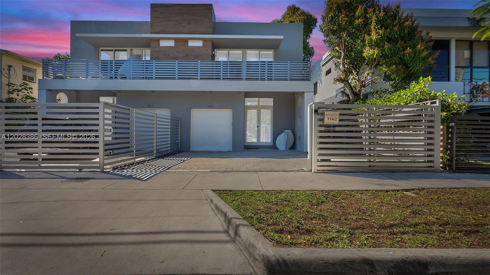 Rare find in the Heart of the Grove! Stunning modern design 4 bedroom, 4 bath gated townhome with top of the line finishes. The open concept design integrates living spaces with the kitchen as its centerpiece with center island, high end appliances, and wonderfully designed for entertaining. All bedrooms are en-suite and located upstairs. The primary suite enjoys a spa like bath and private balcony. Impact glass throughout. Custom remote-controlled blinds. Covered terrace with built in BBQ and pool. One car garage.