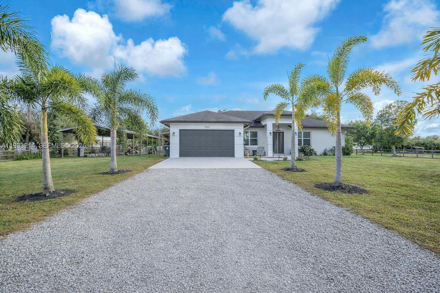 Built in 2020, this STUNNING 4-bedroom, 2-bath home sits on a sprawling 1.14-acre lot with NO HOA & offers a desirable split floor plan with high-end upgrades throughout. Enjoy all-new luxury vinyl plank flooring, dimmable lighting, custom closets, full smart-home features, & full impact windows & doors for peace of mind. The show-stopping kitchen features luxury Café appliances, natural Taj Mahal stone countertops, & a Cristallo stone island with LED lighting—ideal for everyday living & entertaining. The exterior impresses with 3 front entry gates (2 automatic), full exterior gutters, and premium Govee lighting surrounding the home, creating a stunning nighttime ambiance. Outdoor living includes an extended patio, pergola, outdoor fans, RV hookup, & a large pole barn with electric—perfect for storage, equipment, or hobbies. The property also includes a fully enclosed outbuilding with electric, water hookups, and a mini-split A/C, offering versatile flex space ideal for a workshop, creative studio, hobby room, storage, or equipment use. Additional highlights include solar panels that significantly reduce electric costs, underground well system, & 7 exterior Hikvision security cameras. Impeccably designed with upgrades at every turn—MUST SEE!!