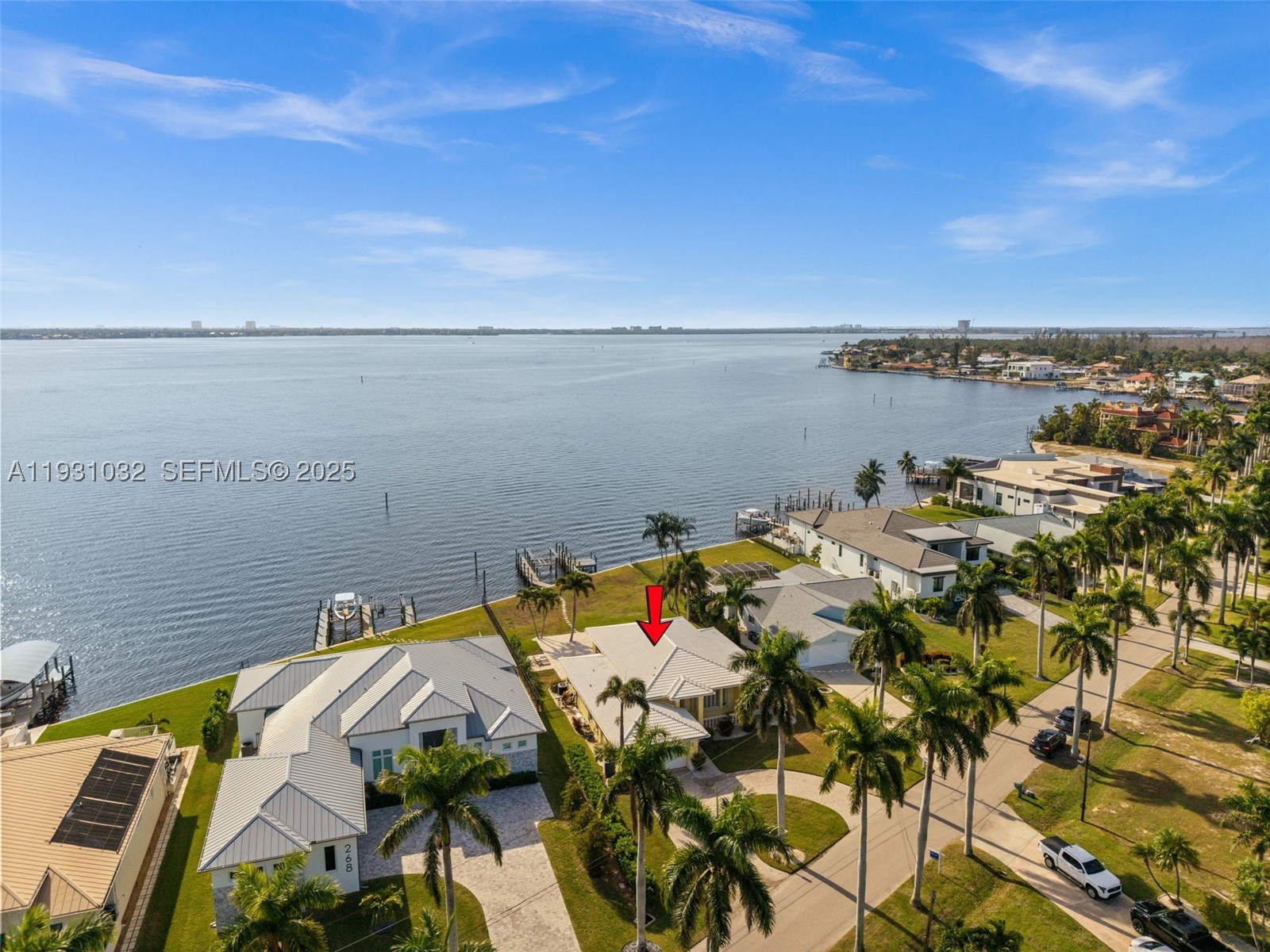 SOUTHERN EXPOSURE RIVERFRONT HOME ON AN OVERSIZED LOT WITH A MULTIMILLION DOLLAR VIEW! This DIRECT RIVERFRONT property is near Cape Coral’s Yacht Club area. SOUTHERN EXPOSURE on an oversized lot with 88 feet of Caloosahatchee River frontage and approx 200 feet of depth, with wide, unobstructed water views and direct sailboat Gulf access with no bridges. NEW SEAWALL installed after Hurricane Ian. Boaters will appreciate the two docks and boat lift. The home features 3 BR,  2 BA, and over 2,200 square feet of living space with 12+ foot ceilings in the main living area. Tile flooring and crown molding run throughout. Open kitchen with granite countertops and walk-in pantry. Two sets of pocketing sliding glass doors with full-length transom windows flood the home with natural light. The primary suite is generously sized with sliding doors to the pool area, two walk-in closets, and a large en-suite bath with dual vanities, a jetted tub, and a separate shower. Outdoors features a heated pool and spa surrounded by a beautiful travertine patio, all overlooking the river. The home does not have a pool cage, allowing for unobstructed views, but is equipped with electric roll-down screens at the rear and accordion shutters for storm protection. Offered fully FURNISHED AND TURNKEY, the property is currently part of a successful vacation rental program. This is a prime opportunity to own one of the most sought-after riverfront locations in Cape Coral.SELLER FINANCING AVAILABLE!