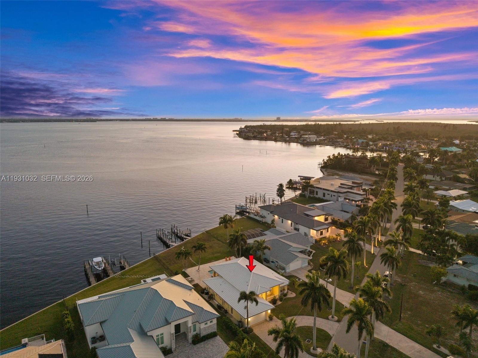 SOUTHERN EXPOSURE RIVERFRONT HOME ON AN OVERSIZED LOT WITH A MULTIMILLION DOLLAR VIEW! This DIRECT RIVERFRONT property is near Cape Coral’s Yacht Club area. SOUTHERN EXPOSURE on an oversized lot with 88 feet of Caloosahatchee River frontage and approx 200 feet of depth, with wide, unobstructed water views and direct sailboat Gulf access with no bridges. NEW SEAWALL installed after Hurricane Ian. Boaters will appreciate the two docks and boat lift. The home features 3 BR,  2 BA, and over 2,200 square feet of living space with 12+ foot ceilings in the main living area. Tile flooring and crown molding run throughout. Open kitchen with granite countertops and walk-in pantry. Two sets of pocketing sliding glass doors with full-length transom windows flood the home with natural light. The primary suite is generously sized with sliding doors to the pool area, two walk-in closets, and a large en-suite bath with dual vanities, a jetted tub, and a separate shower. Outdoors features a heated pool and spa surrounded by a beautiful travertine patio, all overlooking the river. The home does not have a pool cage, allowing for unobstructed views, but is equipped with electric roll-down screens at the rear and accordion shutters for storm protection. Offered fully FURNISHED AND TURNKEY, the property is currently part of a successful vacation rental program. This is a prime opportunity to own one of the most sought-after riverfront locations in Cape Coral.SELLER FINANCING AVAILABLE!