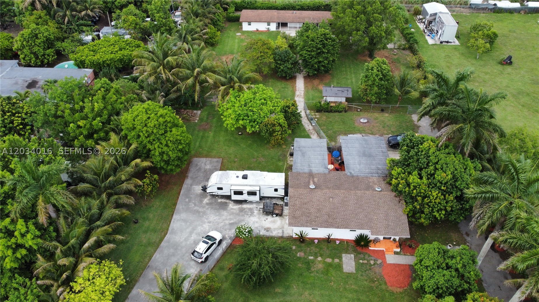 Welcome to this beautifully updated farmhouse estate a rare 1.2-acre offering the perfect blend of privacy, charm, and modern comfort. Main residence remodeled throughout filled w/ abundant natural light, flows seamlessly into an exceptional outdoor entertaining space. The grounds are truly one of a kind, featuring a lush fruit grove over 100 mature trees Lychee, Mango, Avocado, Hass, Star Fruit, Dragon Fruit, Bananas, Coconut palms, Limes and more. Incl 4 horse stalls w/ walk through, expansive open space ideal for equestrian 
enthusiasts, gardening, recreation, RV/boat parking, or future expansion. Fully equipped 1bedroom 1bath guest house with full kitchen perfect for extended family, visiting guests, or rental income. unique opportunity to own a private oasis with charm, functionality