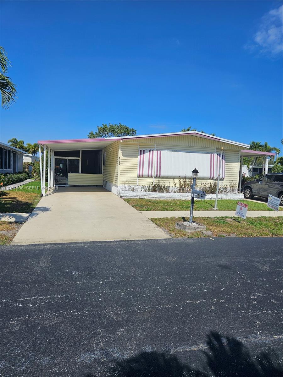 Impressive Corner-Lot Residence in Highland Meadows Estates East. Situated in a 55+ gated community, this 24' x 56' home features 2 bedrooms and 2 bathrooms and a Florida room. The roof was replaced on Nov 2025 along with new A/C ductwork. The home has 2 carports and 2 driveways. Qrtly fees are just $360. Large kitchen with a pantry and cooking island along with seating. Large open floor plan including a spacious living room, dining room and family room with plenty of windows, offering an abundance of natural light. In-unit washer and dryer. Several closets including two walk in closets. Land ownership comes with the property.