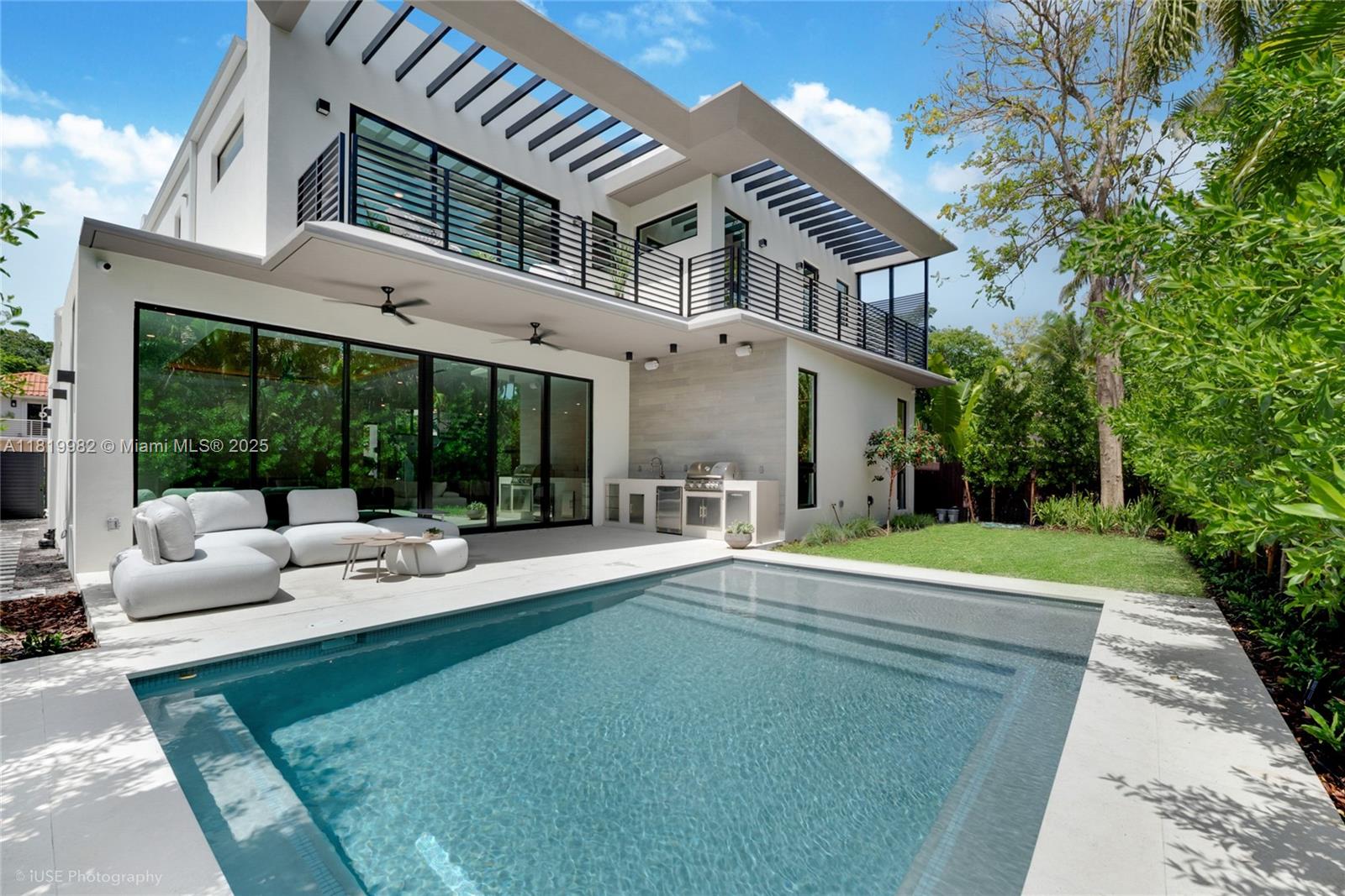 Just completed new construction – immediate occupancy.
A move-in-ready modern residence in Coconut Grove, thoughtfully designed with generous scale, high ceilings, abundant natural light, and exceptional storage throughout, including a dedicated kitchen pantry. This expansive 5-bedroom, 5-bath home features an ideal layout with four en-suite bedrooms upstairs, each with its own private terrace, plus a full fifth bedroom on the main level.

Open living areas flow seamlessly to a well-proportioned covered terrace with saltwater pool and integrated summer kitchen, offering outstanding outdoor living space rarely found in the area. Clean architectural lines, refined finishes, and quality construction throughout. Professionally staged; furnishings available for purchase under separate agreement.