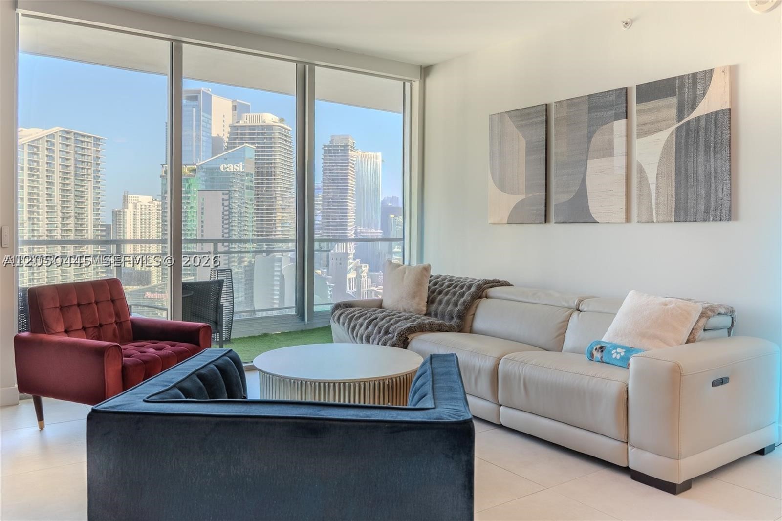 Stunning 37th-floor residence at The Ivy featuring breathtaking panoramic views of the Miami River, Brickell skyline, and Downtown Miami. Floor-to-ceiling glass frames spectacular water and city views, creating an exceptional backdrop from sunrise to sunset. This partially furnished residence offers the perfect blend of luxury, comfort, and convenience within one of Miami's premier gated riverfront communities. Enjoy resort-style amenities and an unbeatable location just minutes from Brickell City Centre, world-class dining, entertainment, and major transportation. Whether you're seeking a primary residence, a second home, or an investment opportunity, this high-floor residence presents a rare chance to own one of the most desirable views in Miami while leaving room to personalize the space with your own style.