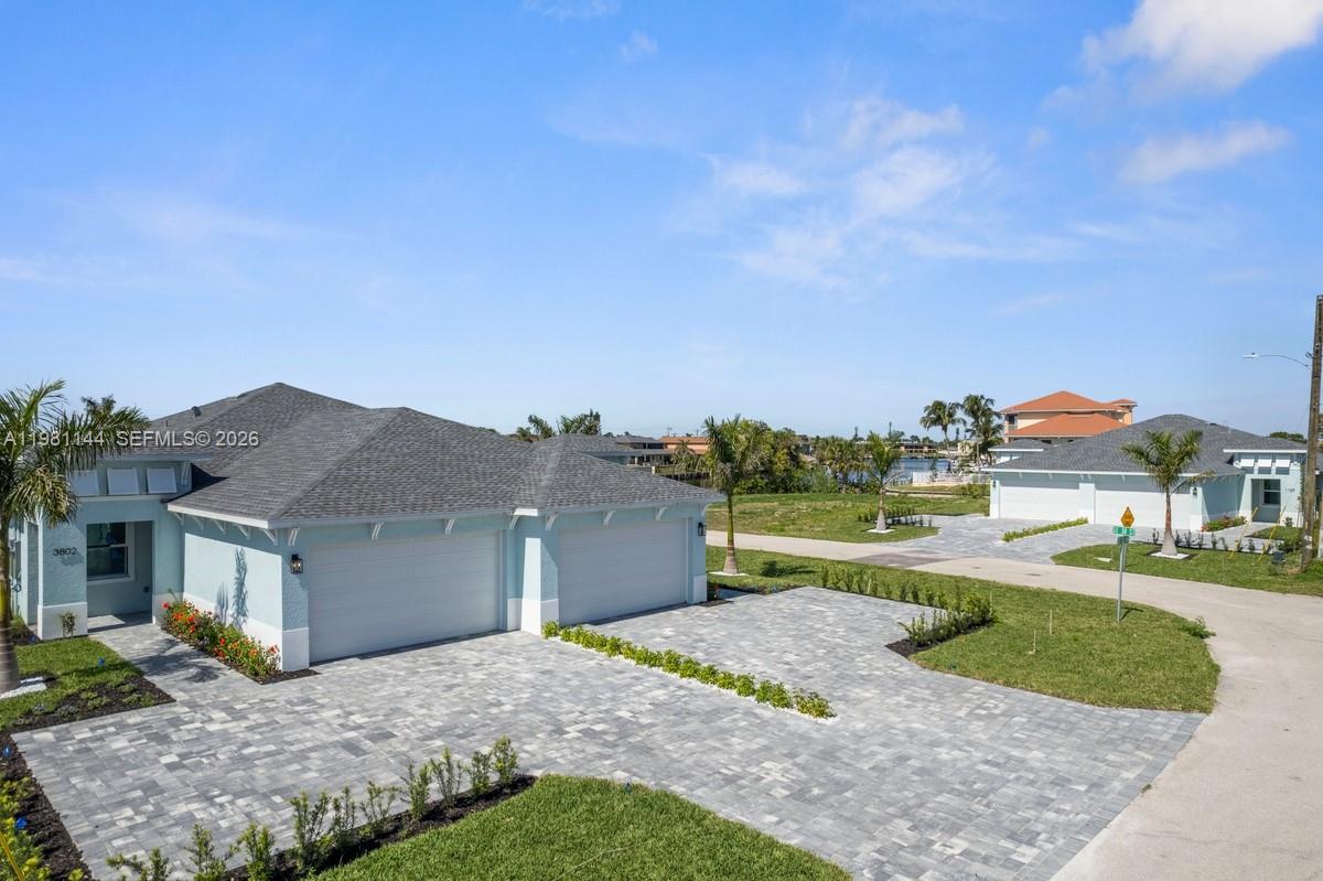Exquisite canal-front residence located in the heart of Cape Coral, FL. Built in 2025, this modern home exudes contemporary elegance on a 0.12-acre lot, offering unparalleled craftsmanship and exceptional amenities. Spanning 1898 square feet of stylishly efficient living space, this home is graced by porcelain tile throughout. It features 3 spacious bedrooms with upgraded closets for your convenience, and 2 pristine bathrooms outfitted with high-quality fixtures, The kitchen is finished with quartz countertops and stainless-steel appliances, framed by upgraded cabinetry. Impact windows & doors throughout the home. Paved driveway and spacious 2-car garage, providing ample storage and parking space. The property boasts Gulf access via its canal front. No HOA. Own a piece of paradise!