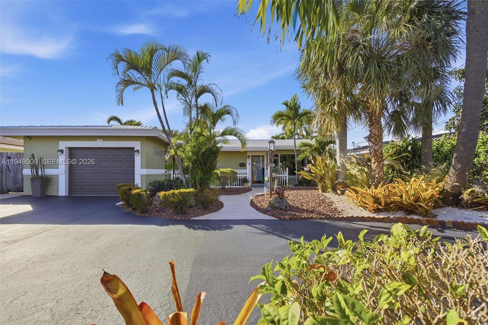 Impeccable and charming Wilton Manors waterfront retreat with ocean access.  This 3 bedroom 2 bath residence features an elegant transitional style open concept kitchen with honey toned wood cabinets, glass fronted upper cabinet sections, matched granite countertops, mosaic tile backsplash, stainless steel appliances and under cabinet lighting.  The primary bath has a bright, coastal inspired design with a fresh blue-and-white color scheme with a frameless glass enclosure shower.  The spacious primary suite has abundant natural light.  The secondary bath offers a large frameless glass enclosure shower finished in large format travertine tiles, and a mosaic tile shower floor.  Porcelain tile throughout the living areas, wood floors in the bedrooms, smooth ceilings and recessed LED lighting throughout. No detail has been overlooked.  Have peace of mind knowing that the roof was replaced in 2018 additional straps were added during installation, electrical updated in 2014, new a/c, ductwork and insulation in 2024. Experience the best of South Florida living with an oasis inspired patio with natural stone pavers and a large in-ground freeform hot tub.  From there you are a few steps away from your dock where you can experience waterfront lifestyle with access to davits with a total capacity of 8,000 lbs and a floating dock, perfect for launching your watercraft.