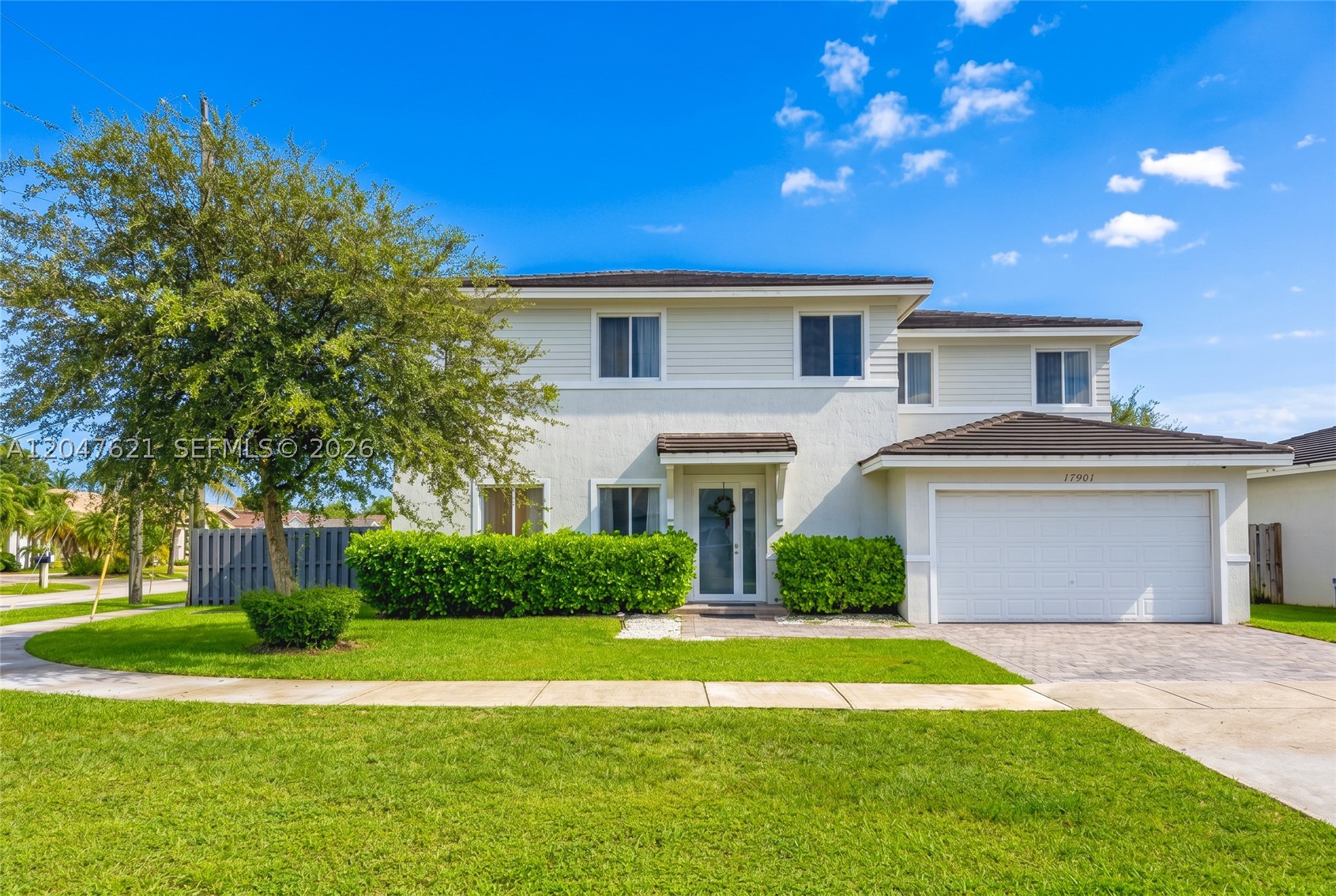 Model-like Home ! This beautifully maintained 2018 corner home offers 6 bedrooms, 3 full bathrooms, and 1 half bath with over 3,000 square feet of thoughtfully designed living space. The open-concept floor plan features high ceilings, abundant natural light, neutral paint, and tile flooring throughout the first floor. The spacious kitchen is the heart of the home, featuring white cabinetry, quartz countertops, stainless steel appliances, a large center island, and plenty of cabinet and counter space, all open to the living and dining areas.

The first floor includes two bedrooms, one full bathroom, and a convenient half bath, providing the perfect setup for guests, extended family, or a home office. Upstairs, the spacious primary suite offers a large walk-in closet and a beautifully designed en-suite bathroom with dual vanities, quartz countertops, a freestanding soaking tub, an oversized glass-enclosed shower, and abundant natural light, creating a true spa-like retreat. Three additional bedrooms and another full bathroom complete the second floor.

Step outside to enjoy a private fenced backyard with a covered patio, perfect for relaxing or entertaining. Additional features include a two-car garage, impact windows and doors, and the added privacy of a desirable corner lot. Conveniently located near top-rated schools, shopping, dining, parks, and major roadways, this exceptional home is ready for its next owner.