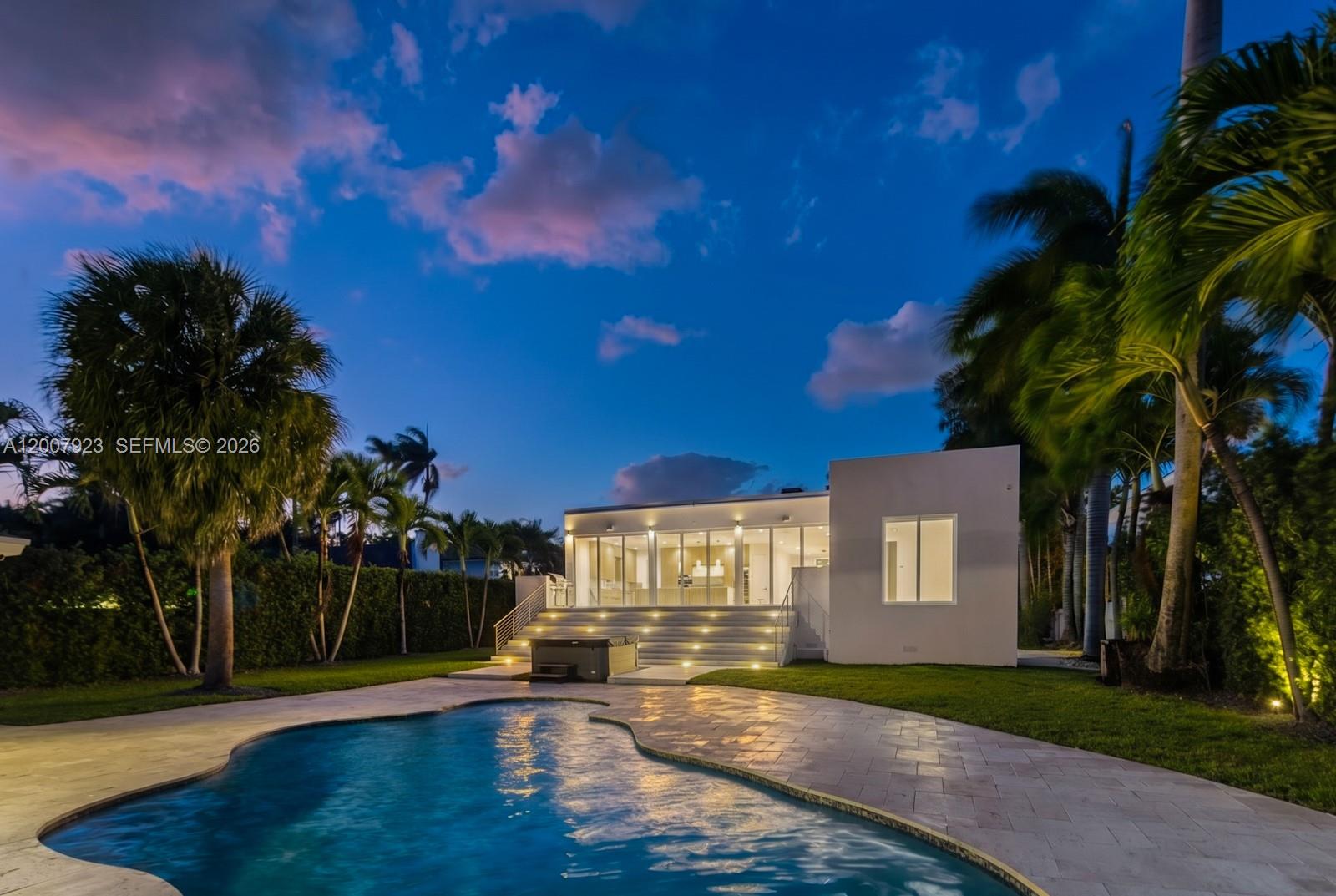 Your private oasis—where modern luxury meets serene waterfront living in one of Miami’s most desirable enclaves near Davis Harbor. This exceptional estate showcases 75 feet of prime water frontage and a 50-foot private dock with no fixed bridges, offering direct ocean access to Biscayne Bay—an unparalleled advantage for boating enthusiasts and yacht owners alike. Designed with a refined luxury presence, this residence is ideal for both elevated entertaining and everyday comfort. Enjoy a private beach and a resort-style heated saltwater pool with a tranquil jacuzzi, all surrounded by lush, professionally landscaped grounds. The expansive travertine deck and top-of-the-line Fisher & Paykel outdoor kitchen create a seamless indoor-outdoor lifestyle, perfect for upscale alfresco dining and hosting. A gated entry ensures privacy and exclusivity, while the detached guest house—currently outfitted as a private gym—offers flexibility as a guest suite, executive office, or maid/nanny quarters. Built in 2015, this turnkey smart home delivers modern architecture, high-end finishes, and the ultimate Miami waterfront lifestyle. A rare opportunity for the discerning buyer seeking luxury, privacy, and direct ocean access—minutes from world-class dining, beaches, and vibrant city life.