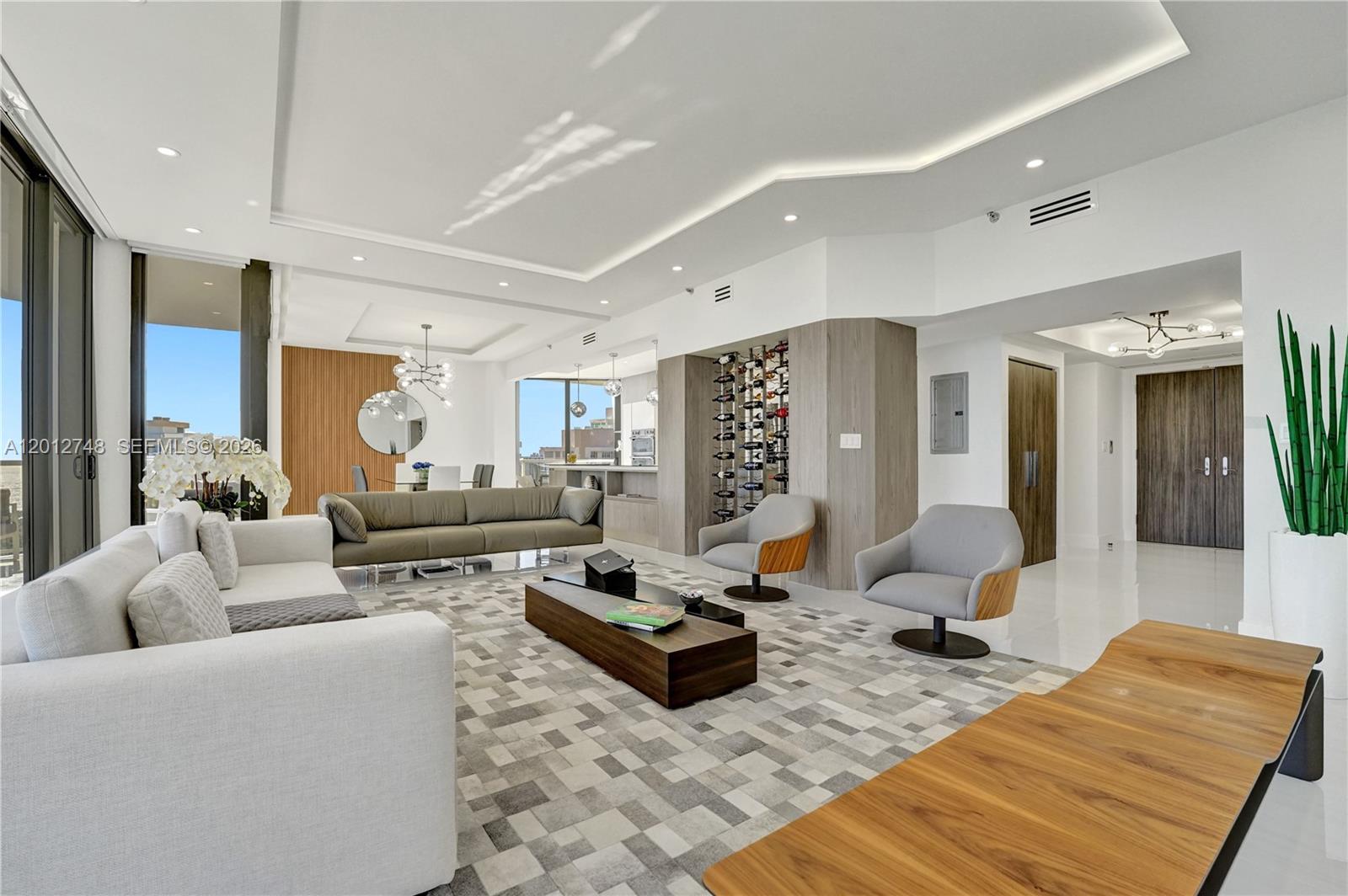 Exquisite, fully renovated penthouse offering the ultimate in luxury living. This impeccable 2 BR, 2BA residence, could be sold as an investment property, Seller is willing to lease it, no need to look for a Tenant. This home was masterfully redesigned for the most discerning buyer seeking elegance & perfection in highly desirable South Florida. Breathtaking panoramic views of the ocean, & golf course. No expense was spared in this custom renovation featuring 10 FT. ceilings, HVAC system w/ upgraded air ducts, new electrical & plumbing, LED recessed lighting, and porcelain flooring throughout. The sleek open-concept kitchen showcases premium Samsung SS appliances, custom Veneta Cucine cabinetry, quartz countertops, multifunction microwave/oven & mounted vintage wine bottle display. The luxurious primary suite offers a spa-inspired bath w/ a Jinox freestanding soaking tub & an oversized shower with LED color jet features. Both bathrooms feature custom cabinetry, while modern custom-designed closets maximize style & function. Imported Italian solid-core doors w/concealed hinges & magnetic locks. Additional upgrades, electric shades, LG washer & dryer, smart home technology & Category 5 high-impact hurricane sliding glass doors that open to expansive balconies accessible from every room, perfect for entertaining. Resort-style living at The Hamptons: 2 pools, a private gourmet restaurant, a Wi-Fi café, a movie theater, fitness center and spa, tennis & racquetball courts, a party room, children’s playrooms & more. Enjoy scenic walks around “The Circle” minutes from beaches, premier dining & shopping.