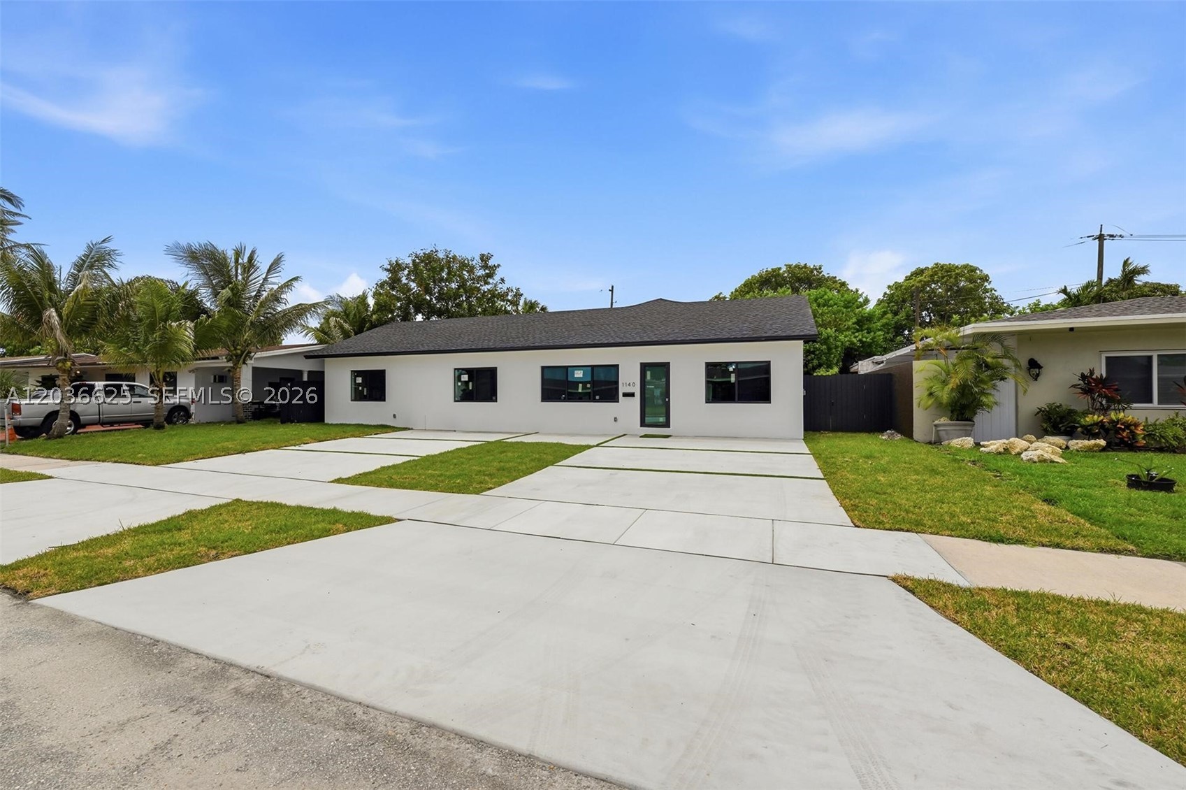Completely renovated 4BD/3BA home offering the benefits of virtually new construction, including an approximately 500 SF addition that expands the living area beyond the square footage currently not reflected Miami-Dade property records. Renovation included a new roof and trusses, all new MEP systems, underground plumbing, septic drain field, electrical panel, ductwork, and a new 5-ton Rheem A/C system. Features include vaulted ceilings, impact windows, new driveway, EV charger connection, tankless water heater, dedicated laundry room, and a designer kitchen with island, coffee station, and under-cabinet lighting. Bathrooms feature contemporary finishes and illuminated smart mirrors. The living room showcases a custom accent wall with detailed paneling. Move-in ready with quality upgrades throughout and significantly enhanced living space.