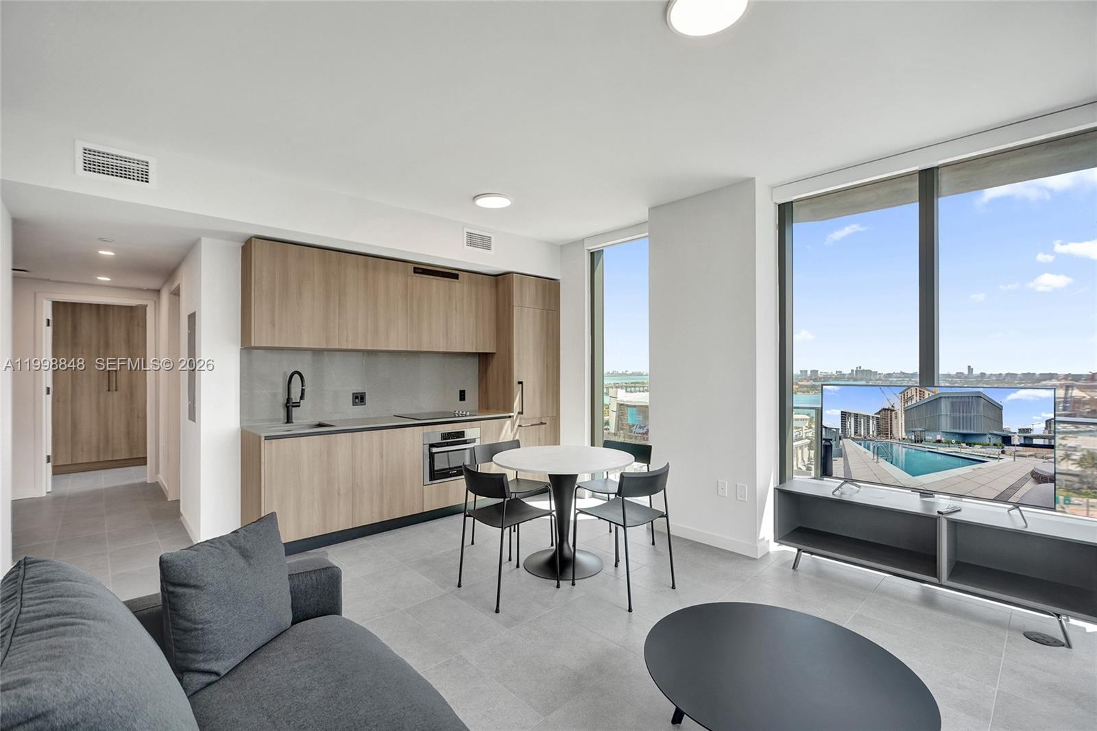 Rare 2 Bed / 2 Bath at 501 First Residences, Downtown Miami's premier new tower. Perched on the 21st floor with a SE-facing balcony, this residence offers 760 sq ft per county records, with the developer's floor plan reflecting 835 sq ft interior + 180 sq ft balcony for 1,015 sq ft of total living area.

Open-concept layout with floor-to-ceiling impact windows, custom Italian kitchen cabinetry, premium appliances, and in-unit washer/dryer. Primary bedroom features a full en-suite bath; second bedroom and additional full bath offer ideal flexibility for guests, roommates, or maximizing rental income. No rental restrictions — Airbnb allowed from day one. Delivered fully furnished and move-in ready.
Enjoy 20,000+ sq ft of amenities: rooftop pool, hot tub, fitness center, 24/7 valet, co-working spaces, pet lounge, and media room — without condo-hotel restrictions.

Steps from Miami Worldcenter, Brightline, Kaseya Center, and world-class dining. Minutes to Brickell, Wynwood, and MIA.

The SE exposure frames iconic views of Biscayne Bay, PortMiami, and the Downtown skyline — among the most photogenic in the building. Unit is brand new and never occupied, offering true first-owner condition. With Downtown Miami's continued growth, strong short-term rental demand, and no income restrictions, this is a rare asset that works equally well as a primary residence, second home, or income-producing investment.