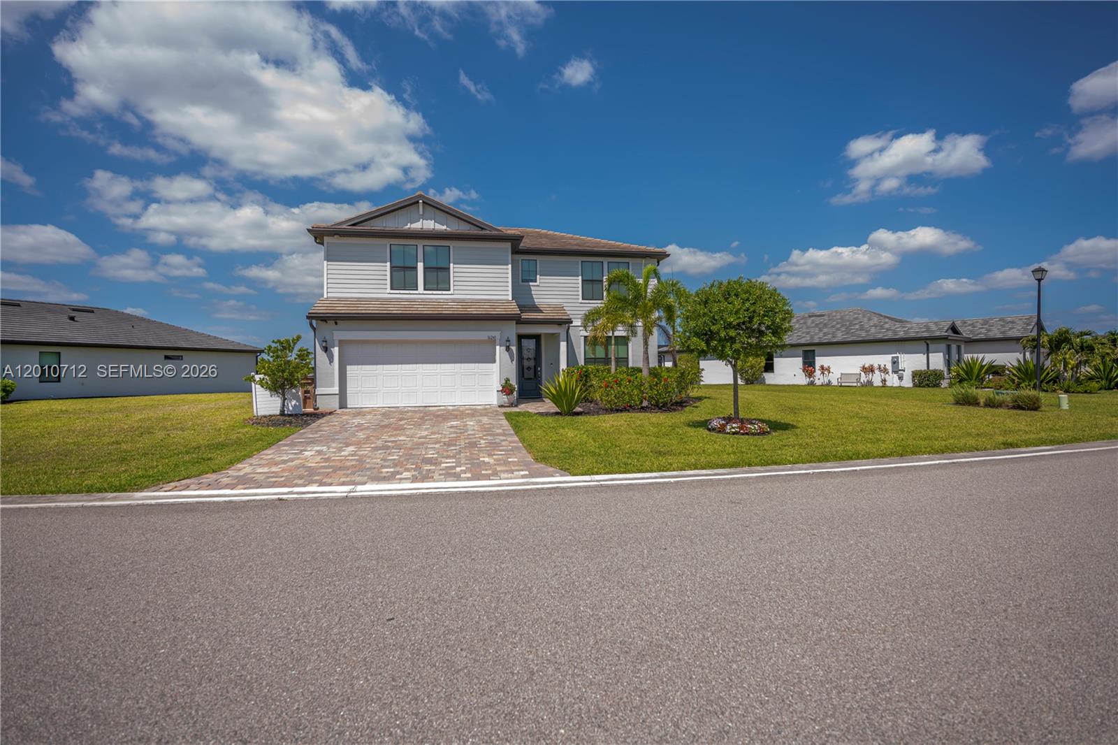 This impressive 5 bedroom/4 bath home was built on an oversized lot within the extraordinary River Hall community and absolutely checks all the boxes. The two-story home boasts an open concept floor plan downstairs where the kitchen, which has a stainless-steel appliance package, beautiful granite counter tops and a full-length island, adjoins a spacious dining room/living area which features a wall of sliding glass doors accessing the lanai. The paver-laid screened lanai, which overlooks the fully-fenced (with 3 gates) backyard and a lovely water view, also has an outdoor kitchen and a wall mounted TV as well as lanai screens which roll down providing ultraviolet light and hurricane protection. Also located on the ground floor is the luxurious master bedroom, which boasts a large closet and a well-appointed ensuite with a shower as well as an additional guest bedroom and bath. Tile floors are found throughout the downstairs while the upstairs is carpeted, except for the bathrooms. A large, comfortable common area can be found on the second floor – perfect for use as a home office or as a family media room. Three additional bedrooms can be found upstairs including a second master and ensuite (which has both a shower and a tub) and two additional guest bedrooms as well as a guest bath with a shower and tub combo. All bathrooms feature tiled showers as well as granite and quartz vanities. This beautiful home has a 2-car garage with sturdy storage shelves as well as a separate laundry room with a washer and dryer (both convey with the sale). Not only does this home have so many designer-inspired features such as the entryway foyer, recessed and contemporary lighting fixtures, and the wide paver-laid driveway, but it also boasts high-tech features associated with a Smart Home which controls door locks, the home’s A/C and the garage door. The ring doorbell camera conveys as does the 3 wall mounted televisions. River Hall is an extremely well-maintained community brimming with amenities which include an active country club and championship golf course as well as multiple swimming pools and recreational facilities. This is the quintessential Florida lifestyle at its very best. Call to schedule your private showing today.