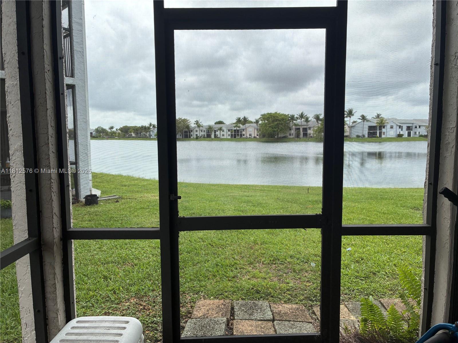 Amazing lake front living in gated Lakeshore community. Unit rear faces a large lake, unit frontage faces greenery, no buildings across for privacy.  First floor, corner unit with washer and dryer in. Screened balcony with storage closets. Amenities include pools, playground, basketball court. East of Turnpike.**best value in Lakeshore**
