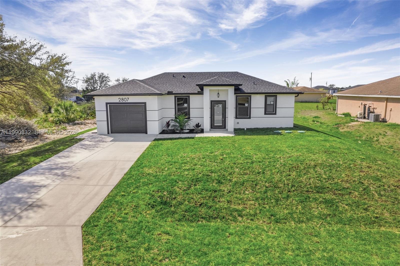 Seller is motivated and ready to make a deal! 10 Year Structural Warranty and 3% seller credit toward buyer’s closing costs. 100% completed and ready to move-in. Be sure to click on the 3D virtual tour! This beautifully designed new construction home sits on a corner lot and offers a modern living space. Featuring 3 bedrooms, 2 bathrooms, and a 1-car garage, the home includes 10-ft ceilings, hurricane-impact windows and doors, built in closets and washer/dryer installed! Enjoy 32x32 porcelain tile flooring throughout, high-profile baseboards, and a spacious kitchen with custom cabinetry, quartz countertops, and a full suite of Samsung stainless-steel appliances. Bathrooms showcase quartz finishes, glass shower doors, and premium fixtures. The property also includes a full irrigation system. Surrounded by new homes, this residence combines style, quality, and value. Don’t miss your chance!