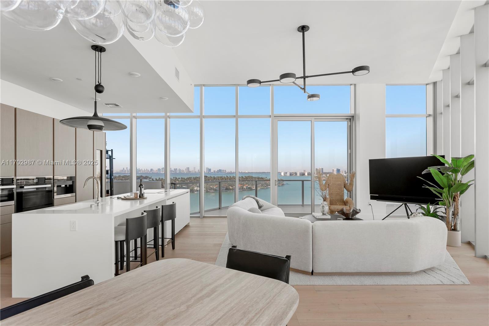 The Penthouse at Monaco Yacht Club redefines luxury living in Miami Beach. Accessible via a private elevator, this stunning residence boasts 13-foot ceilings and is bathed in natural light throughout. Its expansive 3,085-square-foot wraparound terrace offers breathtaking 270-degree views of the Atlantic Ocean and the downtown skyline. Inside, the penthouse showcases wide oak plank flooring, sleek quartz countertops, and premium appliances, including a Miele induction cooktop, Sub-Zero refrigerator, wine wall, and built-in espresso machine. The generously sized primary suite features captivating intracoastal views, abundant closet space, and a luxurious oversized soaking tub. Residents enjoy exclusive amenities such as a fitness center, a rooftop pool with a jacuzzi, and a private marina.