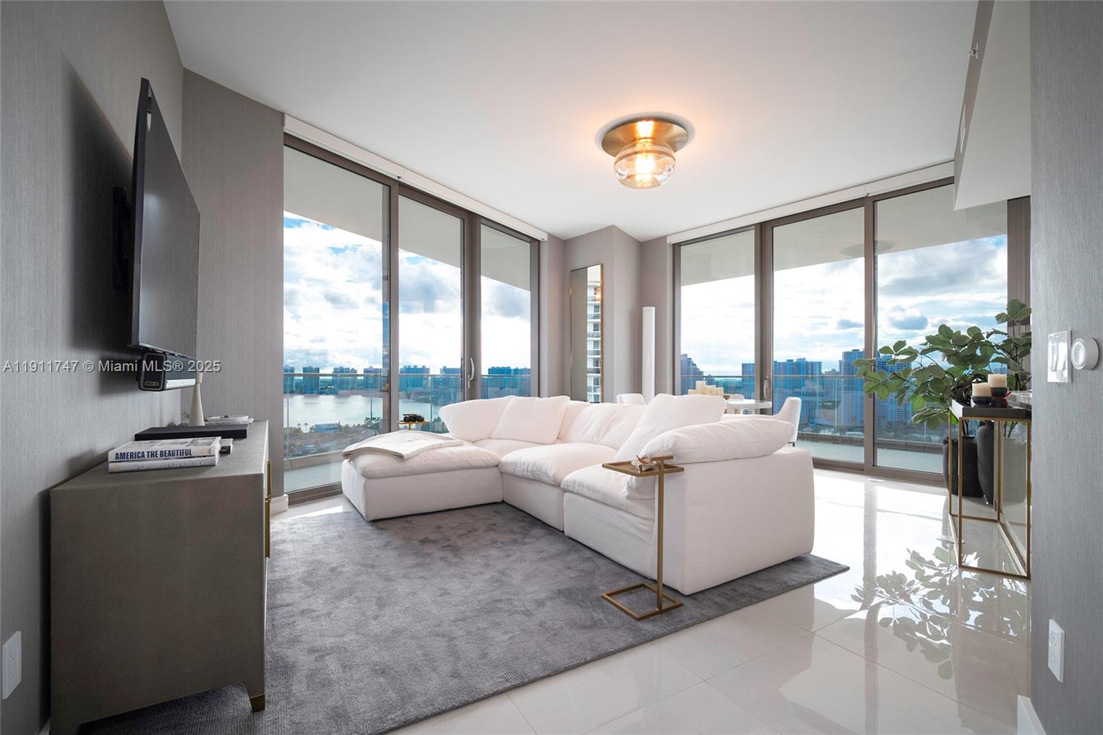 THIS CORNER UNIT HAS UNBEATABLE VIEWS OF INTRACOASTAL, AND OCEAN VIEWS . OVER SIZED WRAP AROUND BALCONY WITH PRIVATE OUTDOOR BBQ WITH REFRIGERATOR, LOFT CEILINGS, SEMIPRIVATE FOYER, SUBZERO FRIDGE, WOLD APPLIANCES AND FULL OF SPECTACULAR AMENITIES SUCH AS GYM, CIGAR ROOM, SPA, WINE ROOM, KIDS ROOM, THEATER, RESTAURANTS, AND PRIVATE POOL AND BEACH SERVICE.