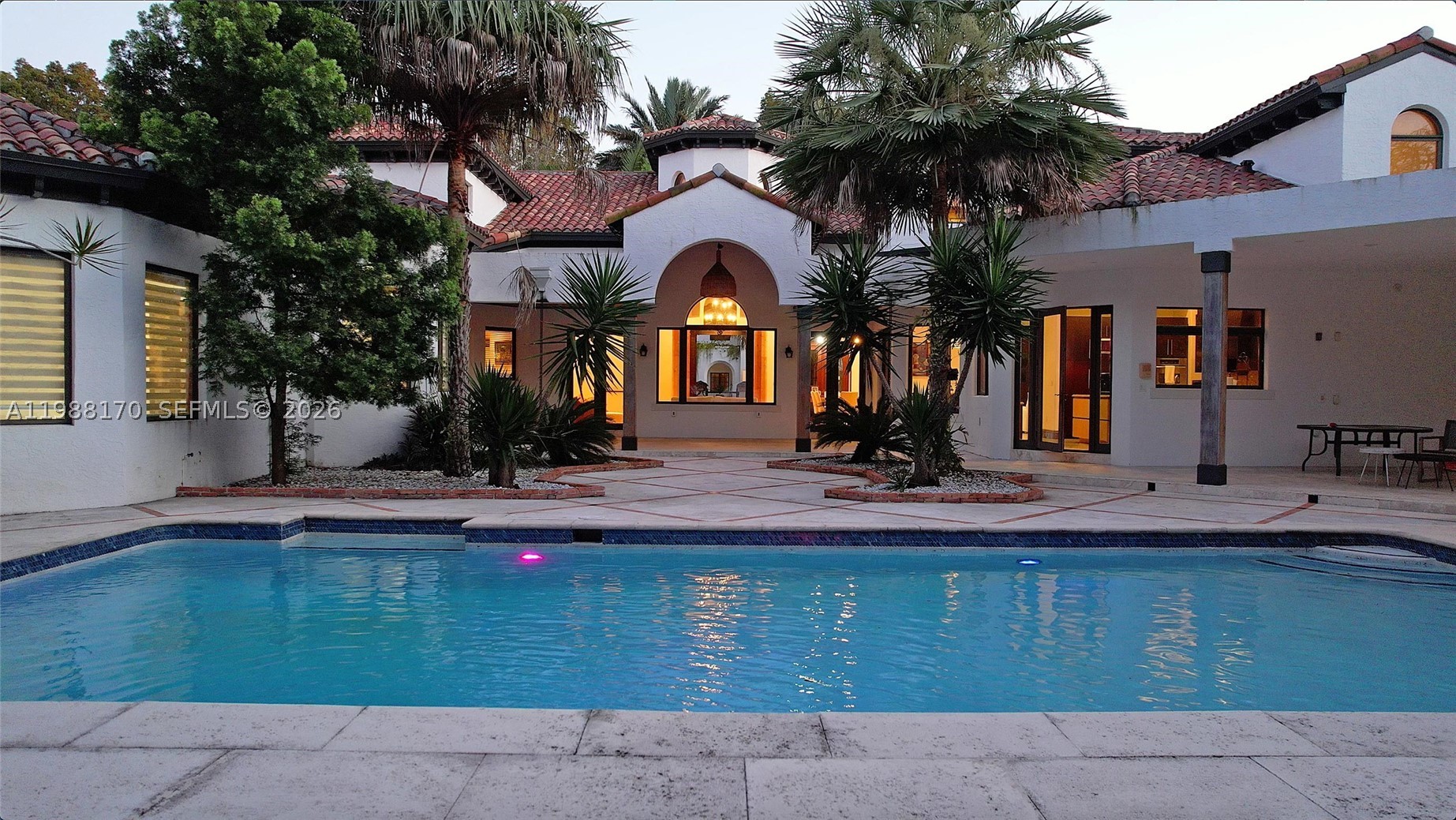 Set on one of Coral Gables finest tree-lined streets, this custom Mediterranean estate is a rare find. Built in 2002, this 6BD/5BA/2HB residence offers 6,887sqft of thoughtfully designed living space on a 19,750sqft lot. The architecture speaks for itself a hand-carved mahogany entry door, soaring octagonal rotunda w/hand-painted ceiling mural, Marble columns, Marble floors throughout and a monumental carved travertine fireplace. The grand living room opens through French doors to a covered loggia with Resort-style living outdoor space, creating a natural flow between interior and exterior that defines true South Florida living. The chef's kitchen is well-appointed with pool views and generous workspace. The expansive primary suite overlooks the pool area and opens directly to the backyard through French doors, offering generous closet space and a serene private retreat. Two kids suites connect through a shared loft play/study space rarely found. A dedicated fitness room with all equipment included, maid's quarters and 2-car garage complete the interior. Outdoors, a cascading waterfall pool, travertine deck and private turf sports court complete the grounds. Minutes to dining, shopping, Historic Miracle Mile and the iconic Biltmore Hotel. This Grand Estate delivers a refined contemporary lifestyle in the heart of Coral Gables. Schedule your tour Today!