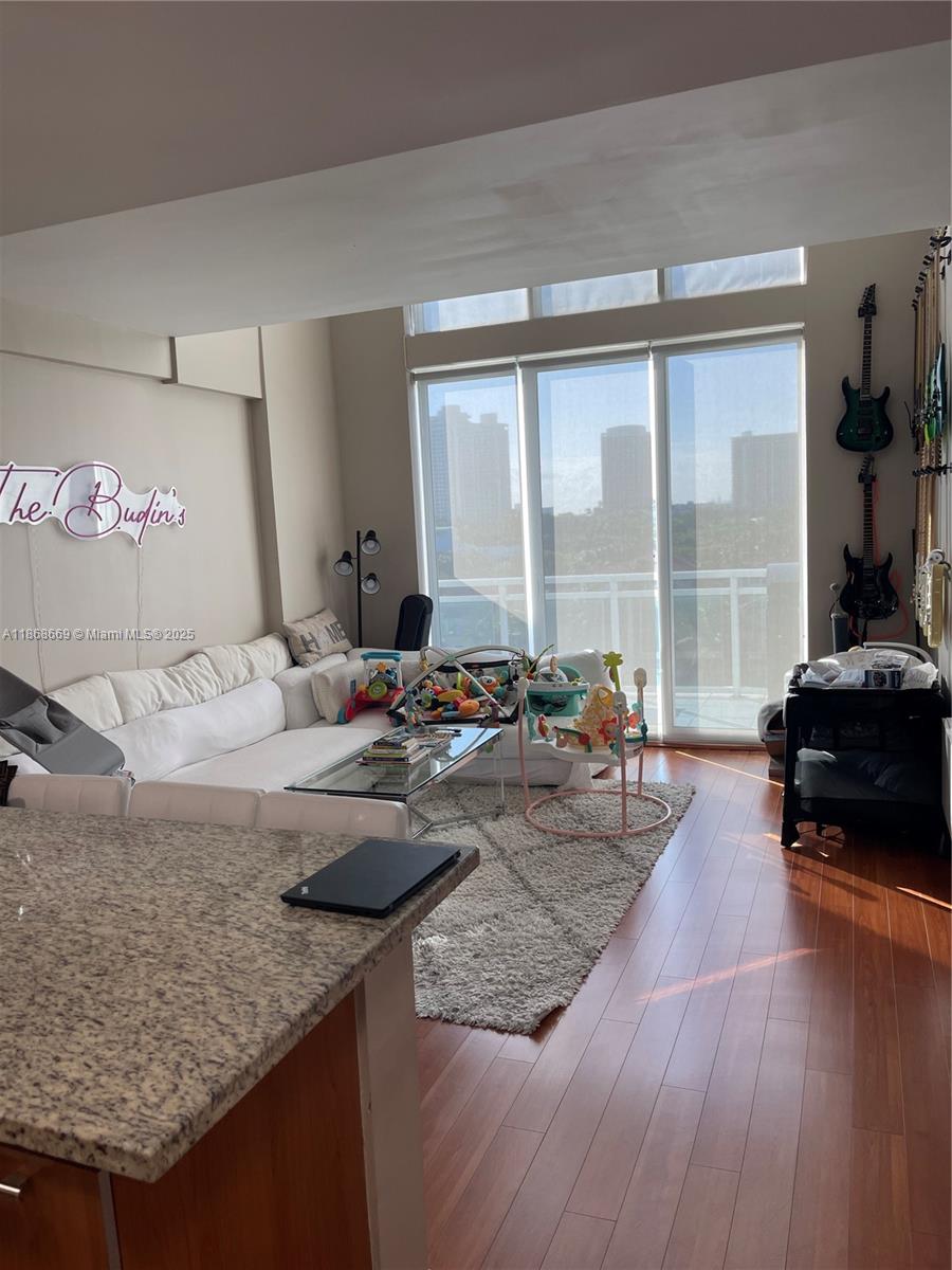 Experience the allure of this Loft style Penthouse boasting 20 ft high ceilings, drenched in natural light. This 2-bed (Den), 2 -bath unit spans 1,330sq ft. The Primary bedroom, situated on the 2nd floor, embraces an open loft concept complemented by expansive walk-in closet. Full-size Washer & Dryer. Step onto the first-floor balcony & soak in serene views of the intercoastal waterways. Securely park in a gated garage, this unit comes with 2 assigned spaces. Building offers amenities such as a gym, sauna, bike storage, community room, boardwalk, pool, & jacuzzi. PRIME location short walk to Peace Park, Publix, places of worship, & renowned restaurants. Enjoy proximity to Aventura Mall & A+ schools. Elevate your lifestyle in this haven with a perfect blend of style, comfort, & convenience!