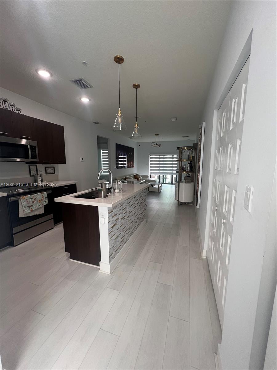 Elegant 3-bed, 2-bath condo in the heart of Doral, offering luxurious, resort-style living in a family-friendly community just steps from Downtown Doral. Walk to top-rated schools, parks, restaurants, and all the entertainment Downtown Doral has to offer — all in a safe, family-oriented neighborhood. Designed with style and comfort in mind, this home features sleek Italian-style kitchen cabinetry, elegant quartz countertops, and top-of-the-line stainless steel appliances — perfect for modern family living. Enjoy resort-style amenities including a stunning clubhouse, resort pool with sun deck and cabanas, fully equipped fitness center, indoor basketball court, running track, business center, and a water park designed for kids — all just steps from your door.