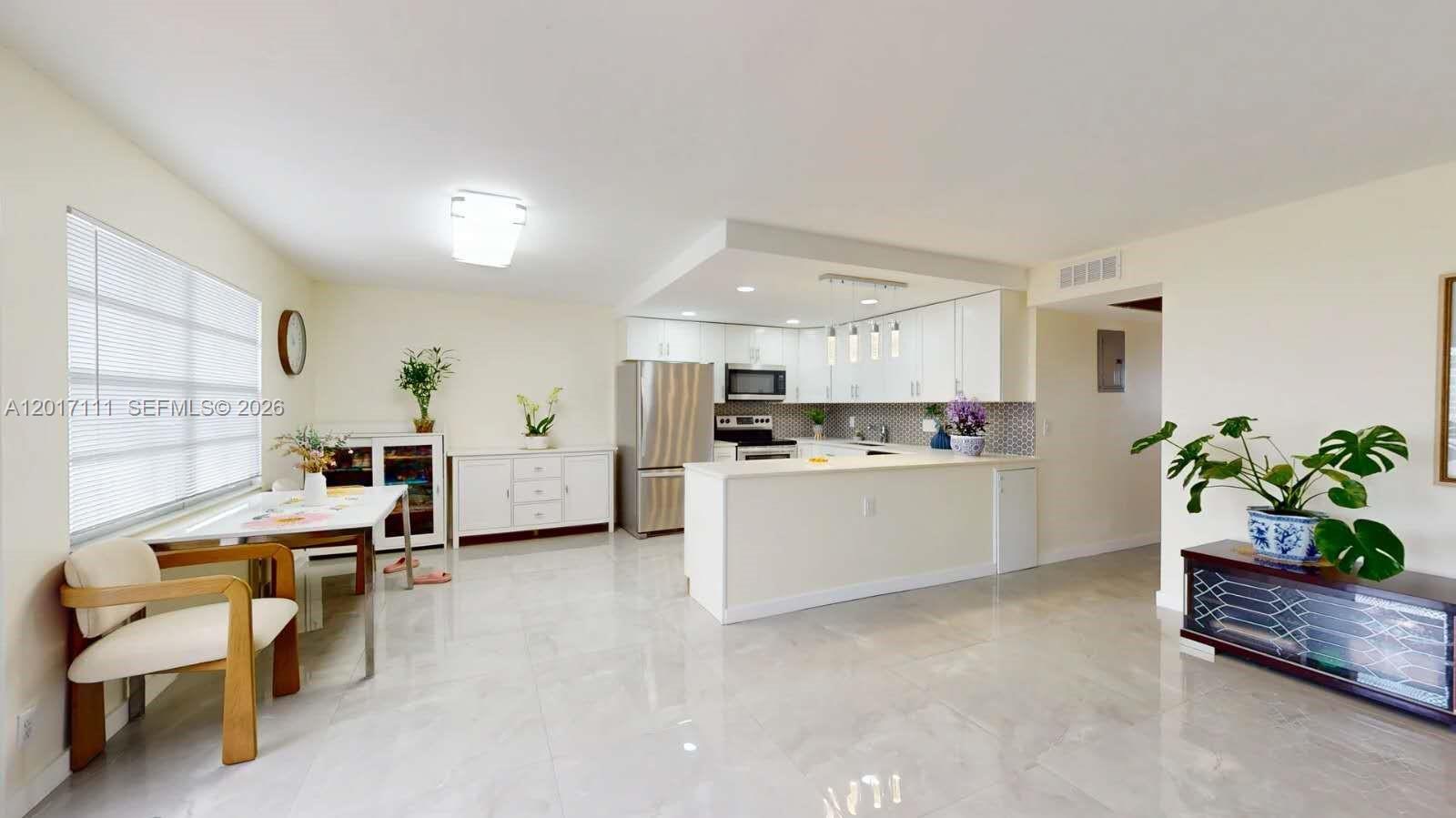Completely renovated waterfront condo located in the highly desirable Century Village community! This bright and spacious residence features a modern open-concept kitchen with white shaker cabinets, quartz countertops, designer backsplash, stainless steel appliances, and a large center island perfect for entertaining. Elegant oversized porcelain tile flooring flows throughout the living areas, complemented by updated recessed lighting and contemporary fixtures. The remodeled bathrooms showcase stylish finishes and upgraded vanities. Enjoy peaceful lake views from the enclosed patio and spacious primary bedroom. Additional upgrades include all impact windows, a 4-year-old A/C system, and newer appliances for peace of mind and energy efficiency. Move-in ready and beautifully maintained with abundant natural light throughout. Resort-style 55+ community amenities include clubhouse, pools, tennis courts, pickleball courts, fitness center, theater, transportation, and endless social activities. Conveniently located near shopping, dining, golf courses, Palm Beach International Airport, and South Florida beaches. Perfect for year-round living or a seasonal getaway!