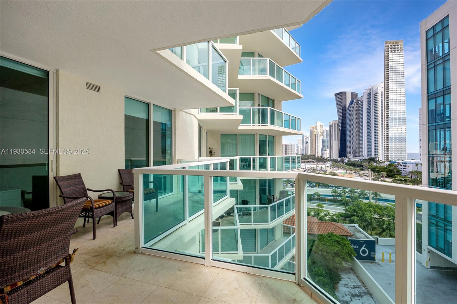 Enjoy this best-priced on a high-floor in the building, elevated coastal living on prestigious Collins Avenue in this 3-bedroom, 2-bath residence with partial ocean, intracoastal, and city views. The well-designed open-concept layout is ideal for everyday living and entertaining, flowing seamlessly to a spacious wrap-around balcony—perfect for relaxing or hosting guests.

The open kitchen connects beautifully to the living area, making cooking and gathering effortless. The primary suite offers a comfortable retreat with a walk-in closet and en-suite bath. Additional features include impact glass windows and an in-unit washer and dryer for added convenience.

Residents enjoy unlimited beach access with full-service beach amenities, catered by a neighboring luxury hotel, delivering a true resort-style lifestyle. The building also offers a fitness center, spa, swimming pool, clubhouse, and 24-hour valet, concierge, and security services. One assigned parking space plus valet included.

Ideally located one block from the ocean, with canal access, a pedestrian promenade, parks, dining, and shops just steps away—an exceptional opportunity to own in Sunny Isles Beach. One of the best-priced 3-bedroom residences along Collins Avenue, offering outstanding value for beachfront living.