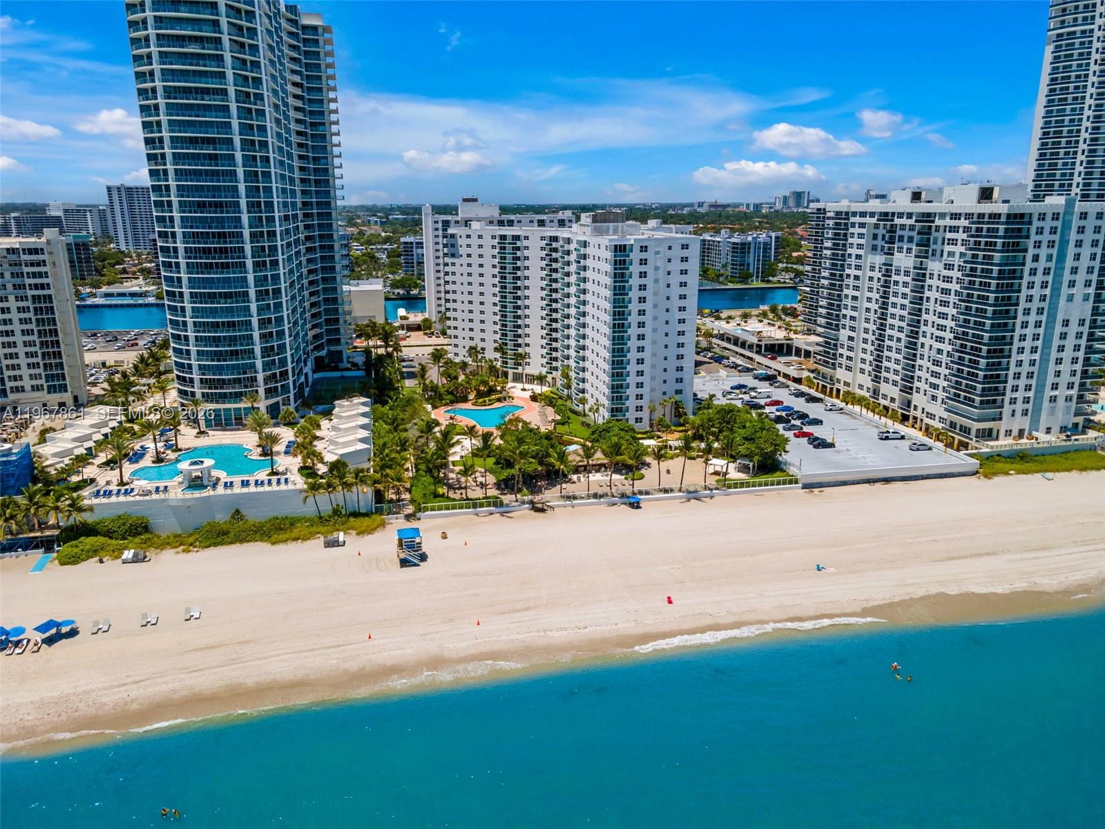 Beautifully updated 2BR/2BA corner condo with split floor plan and partial ocean views in Hollywood Beach. Bright living space with cozy fireplace, updated kitchen with quartz counters and stainless appliances, plus brand new impact windows and doors throughout. Resort-style oceanfront building with direct beach access, two pools, private cabanas, jacuzzi, sauna, tiki bar, fitness center, spa, valet, and 24/7 security. Building has passed its 50-year certification and all updates completed. Prime location near Publix, airports, shopping, dining, and the Hollywood Beach Broadwalk. Seller to pay assessment at closing OR buyer may assume assessment for lower price. Ideal primary home, second home, or investment.