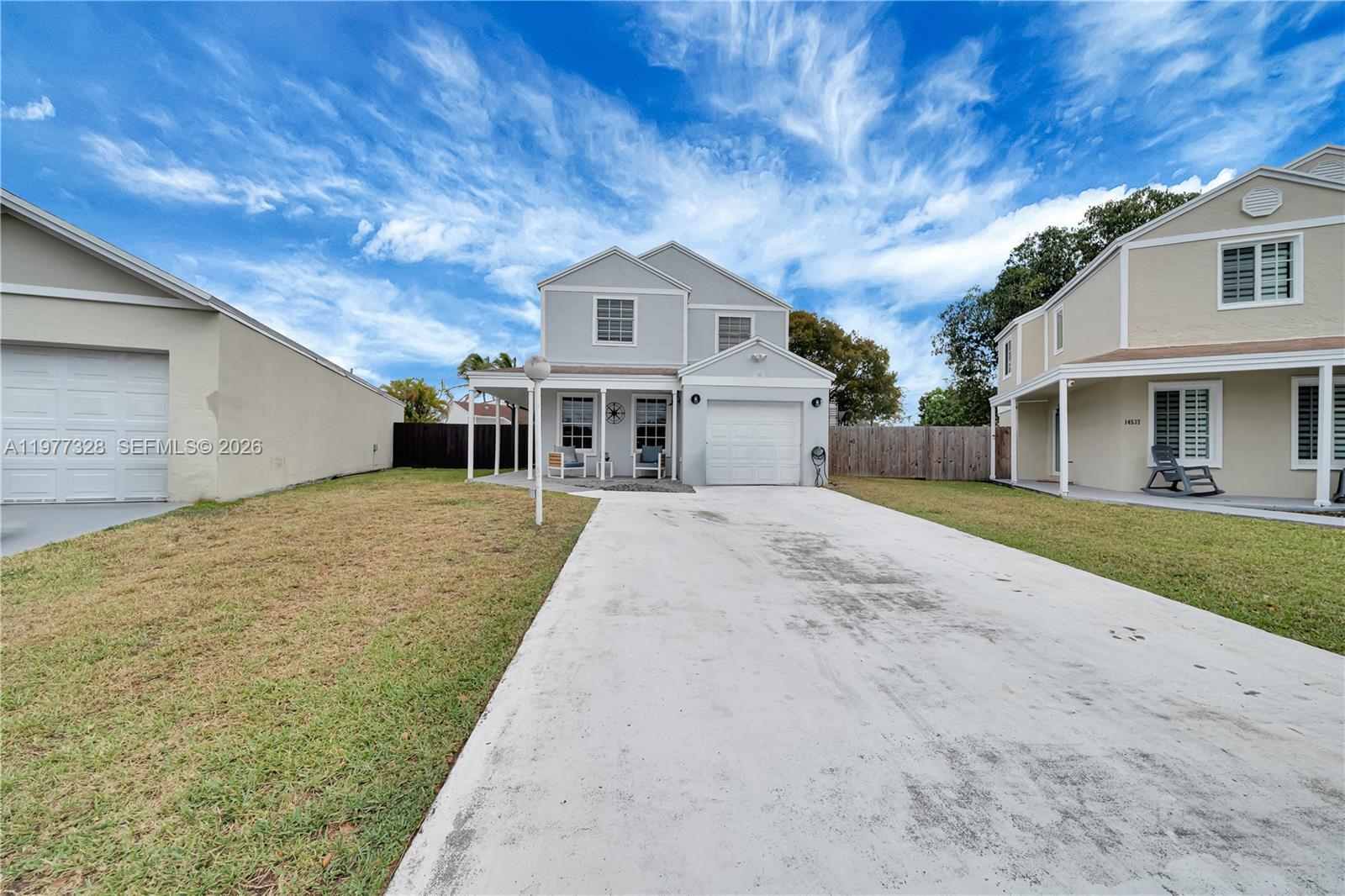 Beautifully remodeled 3 bed, 2 bath two-story home on a quiet cul-de-sac in a super family-friendly neighborhood. BRAND NEW AC WITH NEW DUCT WORK & WATER HEATER! Redesigned kitchen, new TV room and updated bathrooms create a modern, open feel. Enjoy low-maintenance porcelain tile downstairs and durable vinyl upstairs. Outside entertaining is effortless with a summer kitchen and finished outdoor living area — perfect for gatherings and everyday relaxation. Minutes to parks, schools and shopping. Ready to move in!