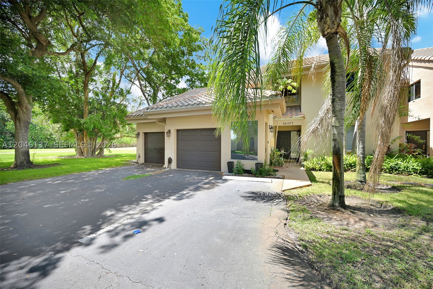 Enjoy peaceful golf course living in this beautifully maintained 2-bedroom, 2-bath corner coach home with a versatile den, ideal as a home office, guest room, or flex space. Offering approximately 1,800 sq. ft. of living space, this move-in ready residence features two private patios overlooking the golf course, where you'll enjoy serene sunrise views and quiet evenings with exceptional privacy thanks to its desirable corner location with no direct views into neighboring units. The spacious primary suite includes two walk-in closets, while the split-bedroom layout, formal dining room, eat-in kitchen, attached one-car garage, and two EV charging stations add everyday comfort and convenience. Located in a meticulously maintained community with a heated pool, tennis courts, top-rated Weston schools, and access to the Bonaventure Town Center Club (membership required), featuring pools, fitness center, tennis, bowling, roller skating, and more.