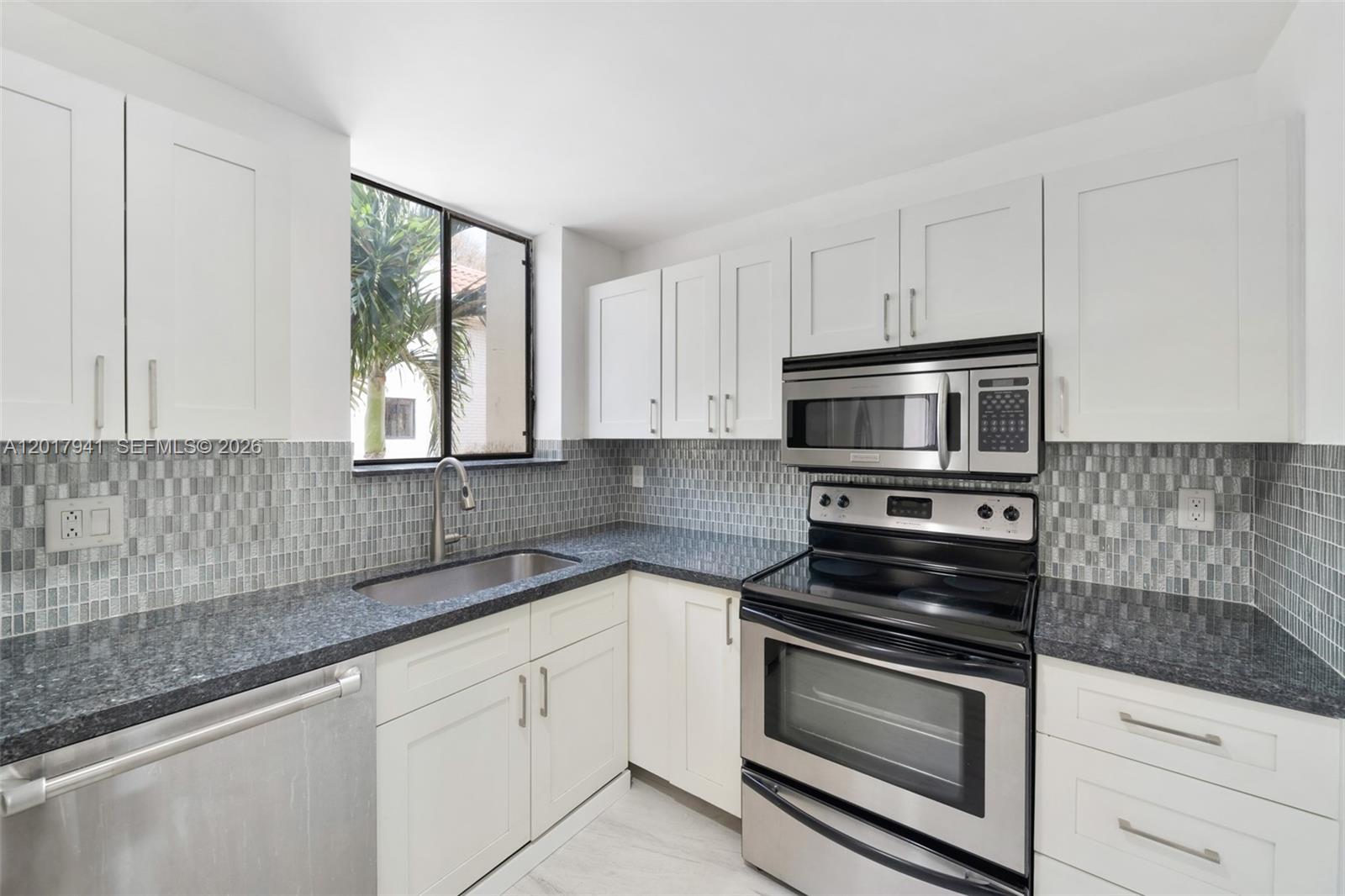 Welcome to Victoria Park Place, the most sought after neighborhood in Fort Lauderdale. This spacious 3 bedroom 2.5 bathroom townhome in Victoria Park Place features real wood floors, modern porcelain tiles, charming Spanish style tiles in the staircase and a 2 car garage. Currently configured as a 2 bedroom plus den but can easily be enclosed again. One of the only units that does not directly face into another unit's back space! In addition to the elevated balcony space is a ground floor courtyard/deck that can extend the garage, be used to add a hot tub, dipping pool or garden area. Roof replacement in 2018 and recent exterior painting completed. This unit is within the gated part of the community. Walking distance from Holiday Park and the Baptist Health Iceplex, 7 minutes from Hugh Birch State Park and Fort Lauderdale Beach, 15 minutes from FLL Airport.