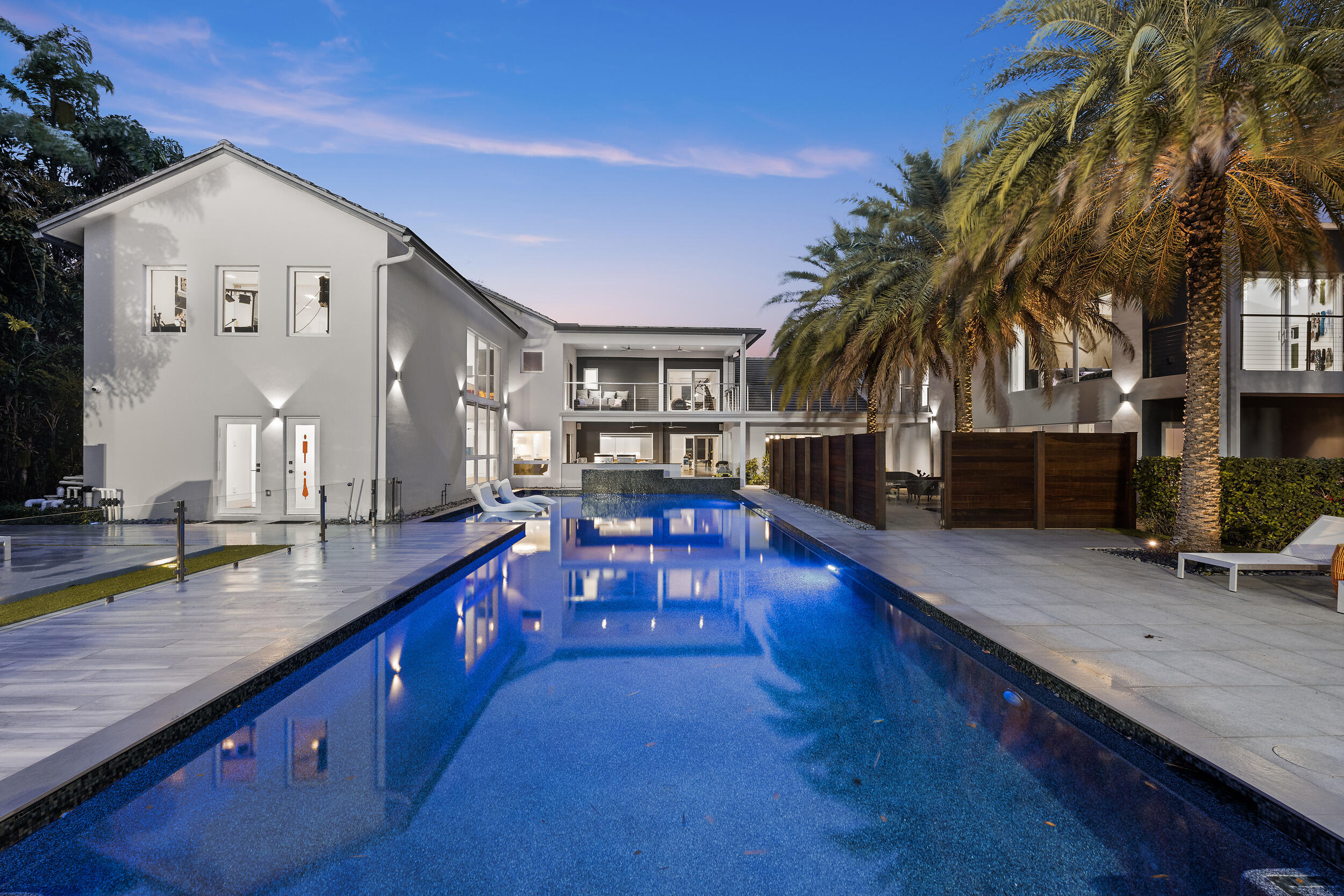 Welcome to your dream home in the highly sought-after Village Del Mar! Built in 2014, this modern masterpiece offers the perfect blend of luxury, comfort, and practicality. Ideally located just minutes from vibrant houses of worship, it provides both convenience and an exceptional lifestyle.

Step inside this stunning two-story home, where elegance meets functionality. Boasting 8 spacious bedrooms, each with a private en-suite bathroom, this home also offers an additional full bathroom, two powder rooms, and multiple versatile bonus spaces, including a dedicated music room.

Designed to impress, the open floor plan is flooded with natural light, featuring soaring ceilings, impact windows throughout, and exquisite designer finishes. At the heart of the home, the gourmet kitchen is a chef's dream, equipped with stainless steel appliances, three Wolf ovens, three dishwashers, three sinks, two gas ranges, and sleek stone countertops. Seamlessly flowing into the expansive living area, this space is perfect for both entertaining and everyday relaxation.
The master suite is a true sanctuary, featuring a spa-like bath with dual vanities and a spacious walk-in closet.

Step outside to your private oasis, where a balcony overlooks a sparkling oversized pool, lush landscaping, and a fully fenced yard offering both privacy and direct access to Powerline Rd. Designed for ultimate entertaining, the outdoor space includes a kitchen, full regulation basketball court, and playground. Additionally, the foundation and plans are in place for a 3-bedroom, 3.5-bathroom guest houseready to be completed if desired.

The oversized multi-car garage provides ample storage.

This gem requires no upgradesschedule your private showing today and start living your dream!