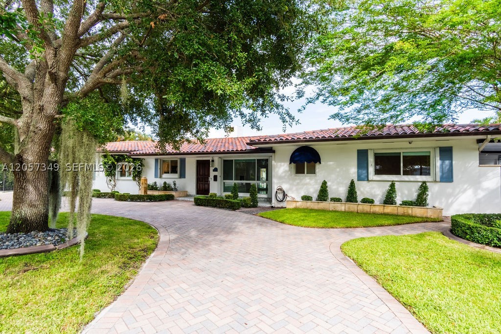 Secluded Lakefront Paradise in the City of Pleasant Living
Experience the perfect fusion of timeless Mid-Century architecture and European elegance in this breathtaking South Miami oasis. Nestled on an expansive 13,000+ square foot lot within the highly coveted "City of Pleasant Living," this rare gem boasts a 107 feet of linear water frontage with panoramic, unobstructed views of Twin Lakes.
Step inside to 2,205 square feet of light-filled, air-conditioned living space designed for seamless modern living. The open-concept layout flows effortlessly, where the spacious living area, dining room, and custom kitchen harmoniously evolve around a cozy focal-point fireplace—all framed by captivating lake backdrops. The home offers a thoughtful split plan featuring 3 generous bedrooms, 3 full bathrooms, and a chic powder room for visitors.
The outdoor spaces are a masterclass in good taste, Mediterranean landscape design. Start your mornings on the quaint, private front patio, or host lavish gatherings on the sprawling back terrace. The ultimate Florida lifestyle awaits on your private lake deck and fully equipped summer kitchen, wrapped in lush, manicured greenery. Marrying peaceful waterfront seclusion with top-tier South Miami location connectivity, this property delivers an unmatched residential profile.