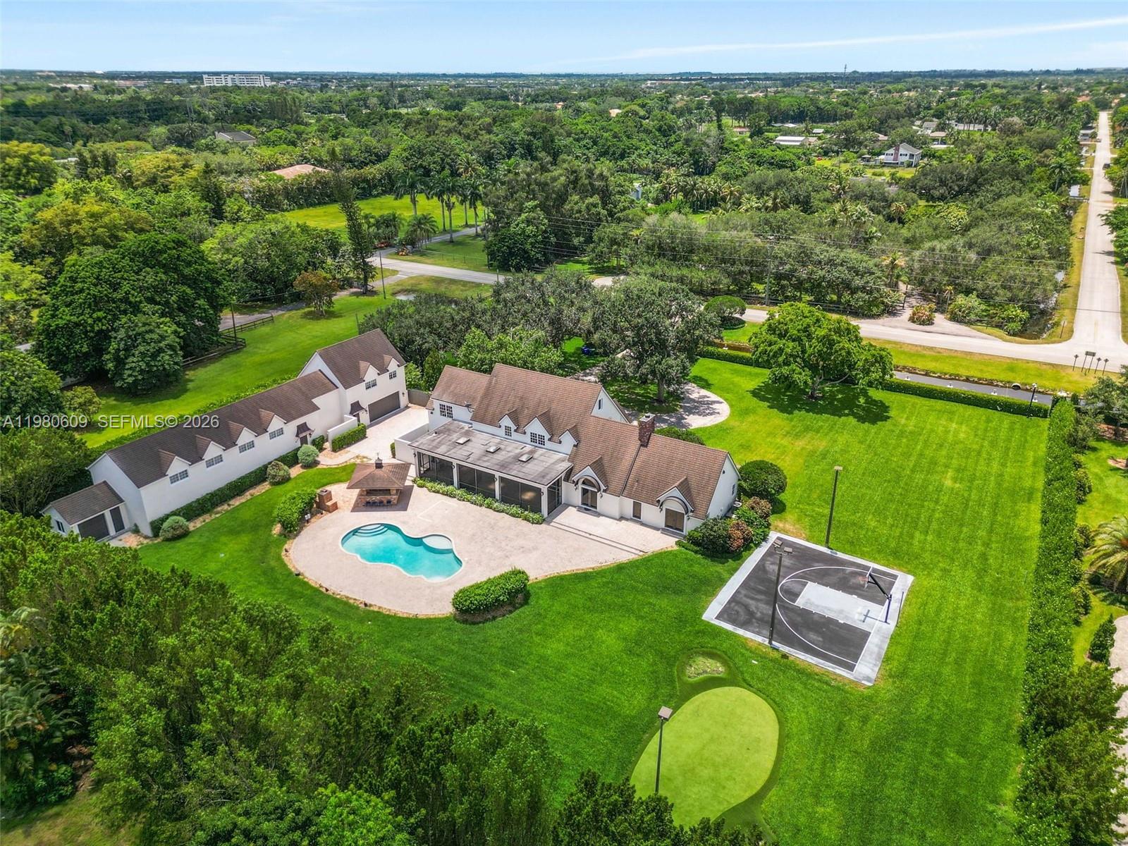 Live in one of the most prestigious areas of Southwest Ranches on coveted Hancock Road, often referred to as the “Florida Hamptons.” This exceptional equestrian estate offers 5 bedrooms, 5 bathrooms, soaring ceilings, and a separate 1-bedroom guest house.
Designed for both luxury living and entertaining, the property features a custom pool, outdoor bar, basketball court, mini-golf area, and a spacious veranda perfect for sunset gatherings. An air-conditioned multipurpose space provides endless possibilities and can be transformed into a recording studio, gym, office, man cave, or sports training area.
Virtual staging shown for illustrative purposes only. Enjoy a unique lifestyle surrounded by equestrian trails, privacy, and the charm that makes Southwest Ranches one of South Florida’s most desirable communities.