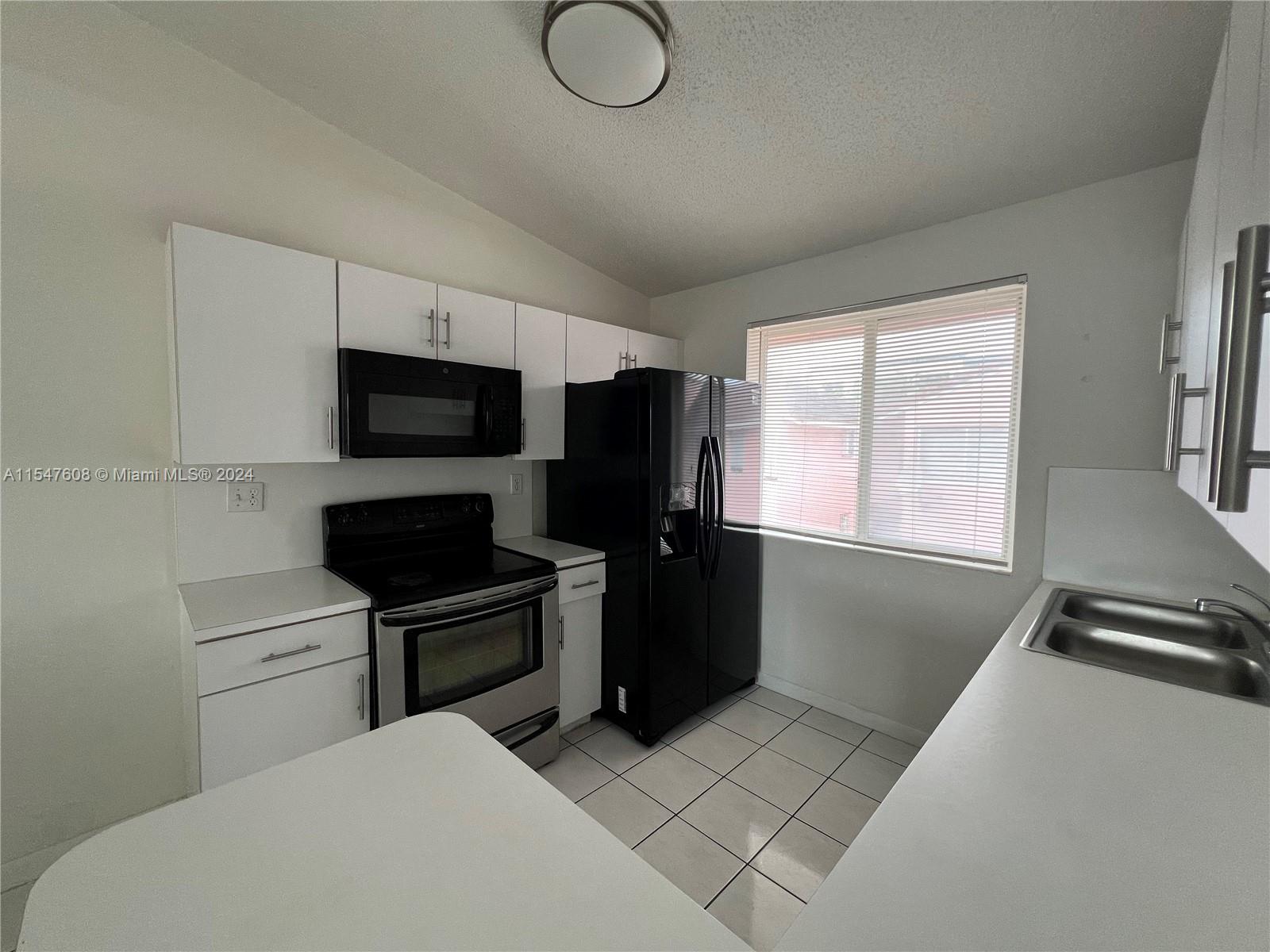Price Reduced! Indulge in this freshly painted condo with new appliances and a convenient in-unit washer and dryer for added ease. Enjoy the nearby tennis court and swimming pool, just steps away from your front door! The 2nd-floor unit features white tile throughout, complemented by two private parking spaces. City Place Doral is a 5-minute drive, Walmart is 10 minutes away, and a gas station is just 2 minutes away. Schedule your viewing today!