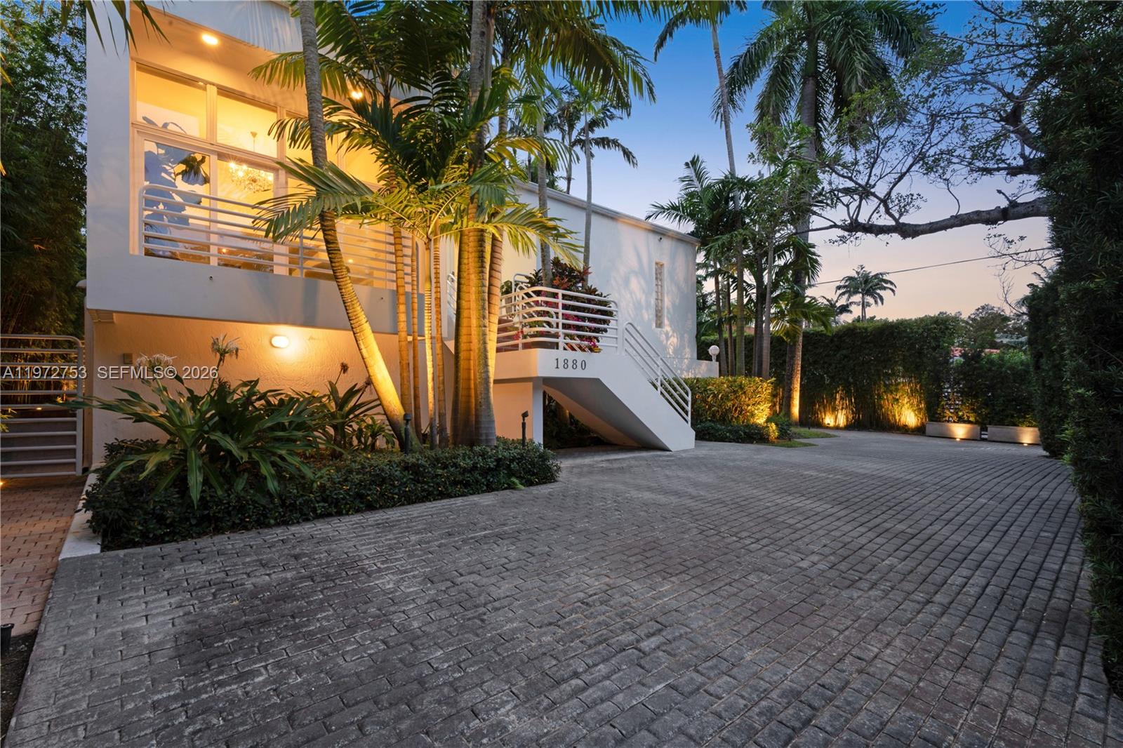 Perfectly positioned on iconic South Bayshore Drive, this private, gated residence offers an exceptional Coconut Grove lifestyle moments from Brickell. Adjacent to waterfront parks and scenic Bayfront paths, the location blends tranquility with easy access to Miami’s financial district, dining, marinas, and top schools. Set on a 9,000 SF lot, the property offers rare space, excellent walkability and privacy. Mature landscaping enhances the seclusion, while natural light fills the interiors, bringing lush garden views indoors and highlighting tall ceilings. Improved over the years, the home offers a timeless foundation to enjoy as is or elevate further. The third floor features the primary suite with walk-in closet and full bath, a second bedroom with full bath and balcony, and a laundry area. The second floor offers a generous bedroom suite. The ground level includes a full separate living quarter with private entry and kitchen, a full bedroom, plus a gym/flex room and additional laundry room—ideal for guests or extended family. The villa was re-roofed in 2018 and features impact windows and doors and brand new A/C handlers.  A beautiful saltwater pool anchors the backyard, creating a peaceful and private retreat ideal for entertaining and relaxing, while landscape lighting and a fire pit create a beautiful evening ambiance surrounded by lush tropical landscaping. An oversized garage, off-street parking for up to 12 vehicles, and a dog park/play area complete the offering.