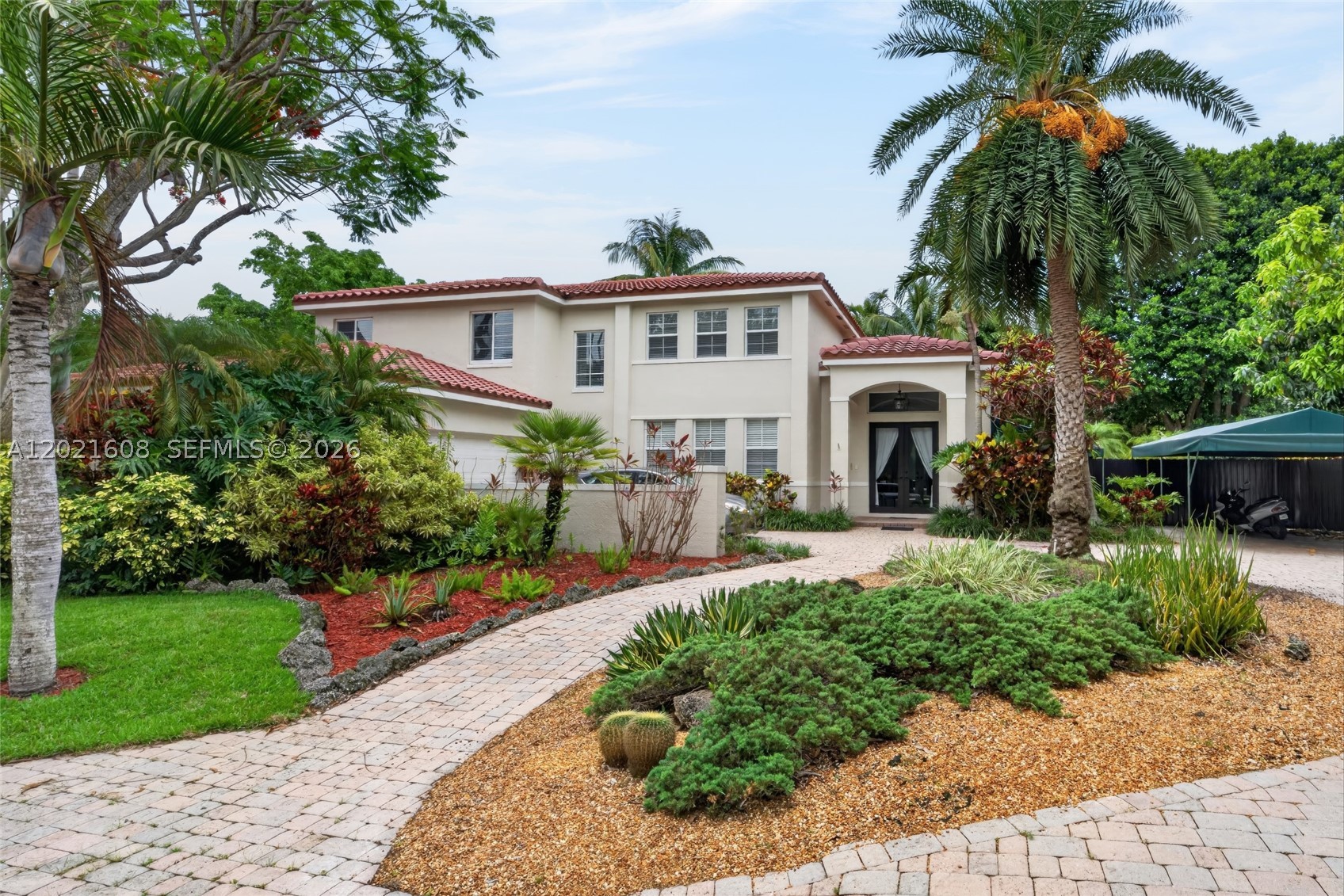 Beautifully updated 5BR/3 BA residence located in the highly desirable gated community of The Groves at Old Cutler. Positioned in one of the best locations within the community, this home sits directly across from expansive green space, a massive park, and a charming community gazebo, creating a unique open feel and an incredible extension of your own backyard. Perfect for outdoor gatherings, birthday parties, or a place where kids can play and truly make the space their own.

This spacious two-story home features a completely remodeled kitchen with double ovens, induction cooktop, exterior-vented exhaust hood, and garbage disposal, a barrel tile roof replaced in Fall 2020 with 50-year-rated underlayment, impact windows and doors installed in Fall 2020, a recently resurfaced pool, brand-new flooring throughout the entire second floor, and a 2-car garage. Double-height ceilings and abundant natural light create an inviting atmosphere throughout the main living areas.

The oversized primary suite offers a private sitting area, large walk-in closets, spa-like bath with double vanities, soaking tub, and oversized shower. Step outside to your tropical backyard oasis complete with a screen-enclosed, heated saltwater pool, covered terrace, lush landscaping, fruit trees, and dedicated space for your boat or RV. Large outdoor entertaining areas make this home perfect for enjoying the South Florida lifestyle. A rare opportunity in an exceptional family-friendly community.