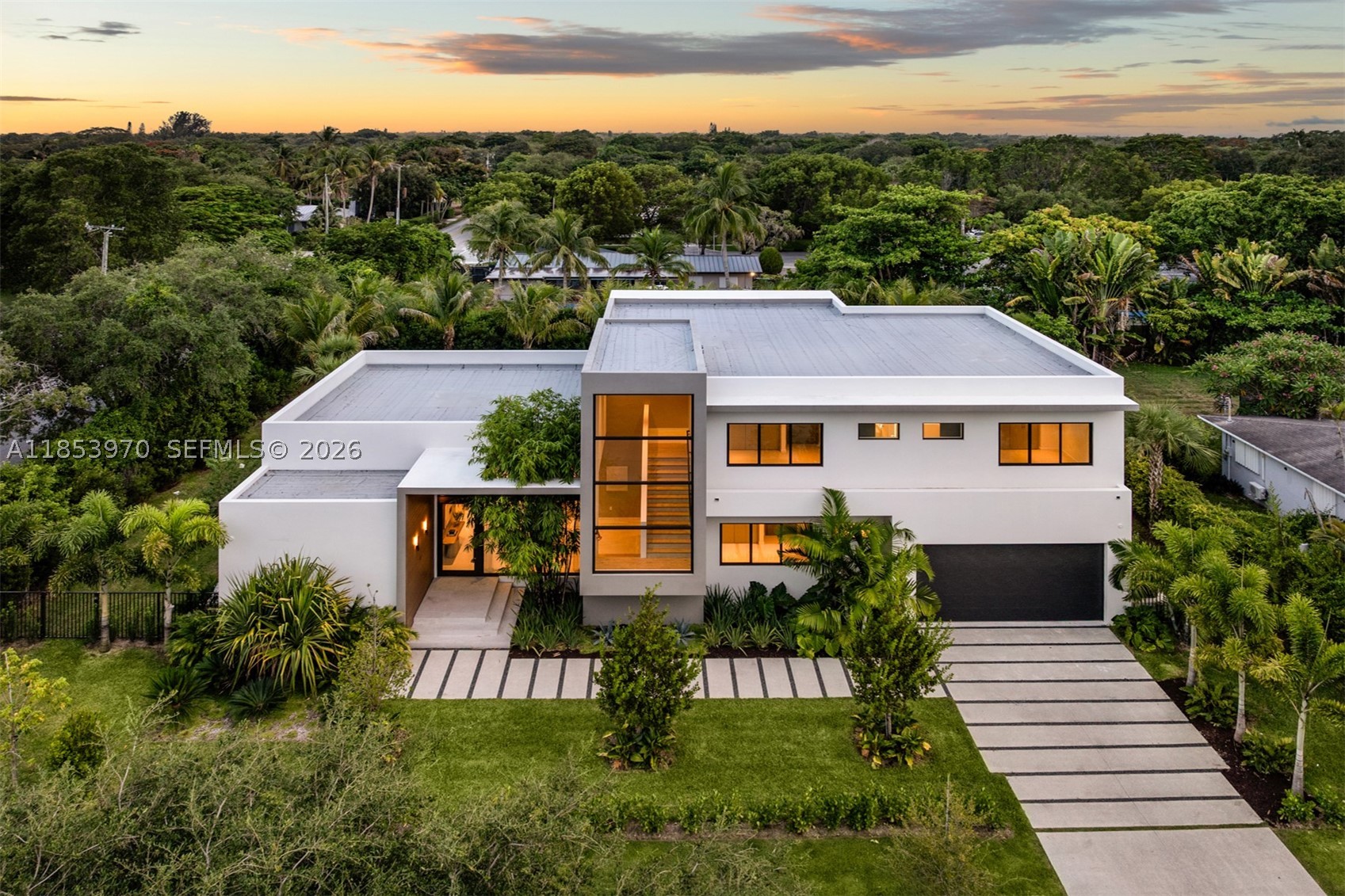 Introducing a distinguished new construction on a premier corner lot in the heart of Pinecrest, where timeless elegance meets modern design. This two-story residence features soaring ceilings, a grand entry, impact windows, custom Coblan cabinetry, and a chef’s kitchen with Miele appliances. The expansive great room opens to a sleek modern pool and covered terrace, perfect for entertaining. Two bedrooms on the main level, one with a private entrance, provide ideal accommodations for guests or multigenerational living. Upstairs, three en-suite bedrooms accompany a luxurious primary suite with a spa bath, oversized closet, and private terrace. A two-car garage and future-ready smart home integration complete this exceptional offering.