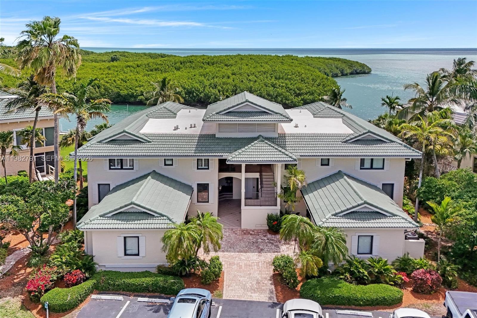 Welcome to your easy-living retreat at 41A Pumpkin Cay of Ocean Reef Club. This beautifully updated 4-bedroom, 3.5-bath ground-floor condo offers a bright, open layout designed for gathering family and friends. It’s truly move-in ready, featuring a brand-new AC (2026), a new roof (2025), and newly installed impact sliding glass doors that open to your screened-in porch—perfect for those slow mornings watching the sunrise. The heart of the home is the modern kitchen (updated in 2021), featuring quartz countertops, sleek stainless steel appliances and generous cabinet space. Whether you’re hosting a dinner or a casual happy hour, the custom bar—complete with a new Scotsman ice maker and wine fridge—makes entertaining a breeze. One of the four bedrooms offers great flexibility as a home office or guest suite, featuring a built-in queen Murphy bed. For the boaters, your assigned 29-foot dock is just steps away in a protected canal with quick ocean access. Offered fully furnished, this residence is ready for you to move right in and start making memories in the heart of Ocean Reef.