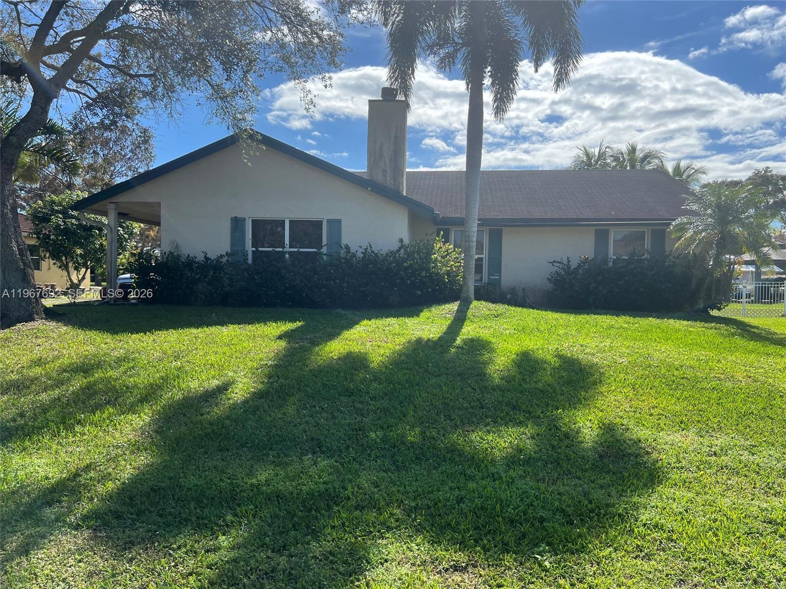 Beautiful Canal front home on a 1/3 of an Acre located in the highly desirable area of Plantation Acres! This 3-bedroom, 2-bath residence sits on an oversized lot featuring a spacious backyard with plenty of room to design and build your dream pool, create an outdoor oasis, or expand entertaining space. Enjoy tranquil water views from your backyard while still being close to everything you need. The home offers a functional layout with comfortable living areas, a dedicated dining space, and abundant natural light throughout. Ideal for both everyday living and hosting guests, the property provides endless potential to personalize and make it your own.The large yard is perfect for pets, gardening, or outdoor gatherings, and the canal frontage adds privacy and a peaceful atmosphere rarely found at this price point. No mandatory HOA provides added flexibility for homeowners and investors alike. Conveniently located near major highways, shopping centers, dining, parks, and top-rated schools, this property combines location, land, and lifestyle.A rare opportunity to own a waterfront home with generous outdoor space in one of Plantation’s most sought-after neighborhoods—schedule your private showing today!